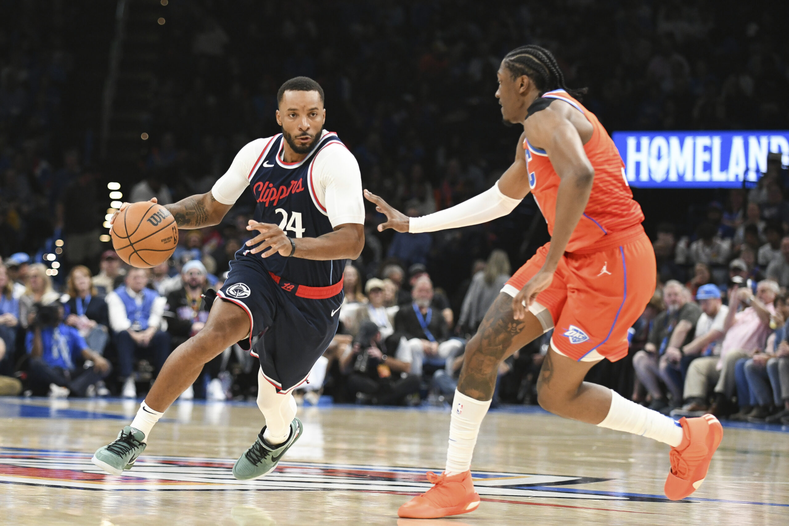 Clippers guard Norman Powell, left, drives past Oklahoma CIty Thunder...