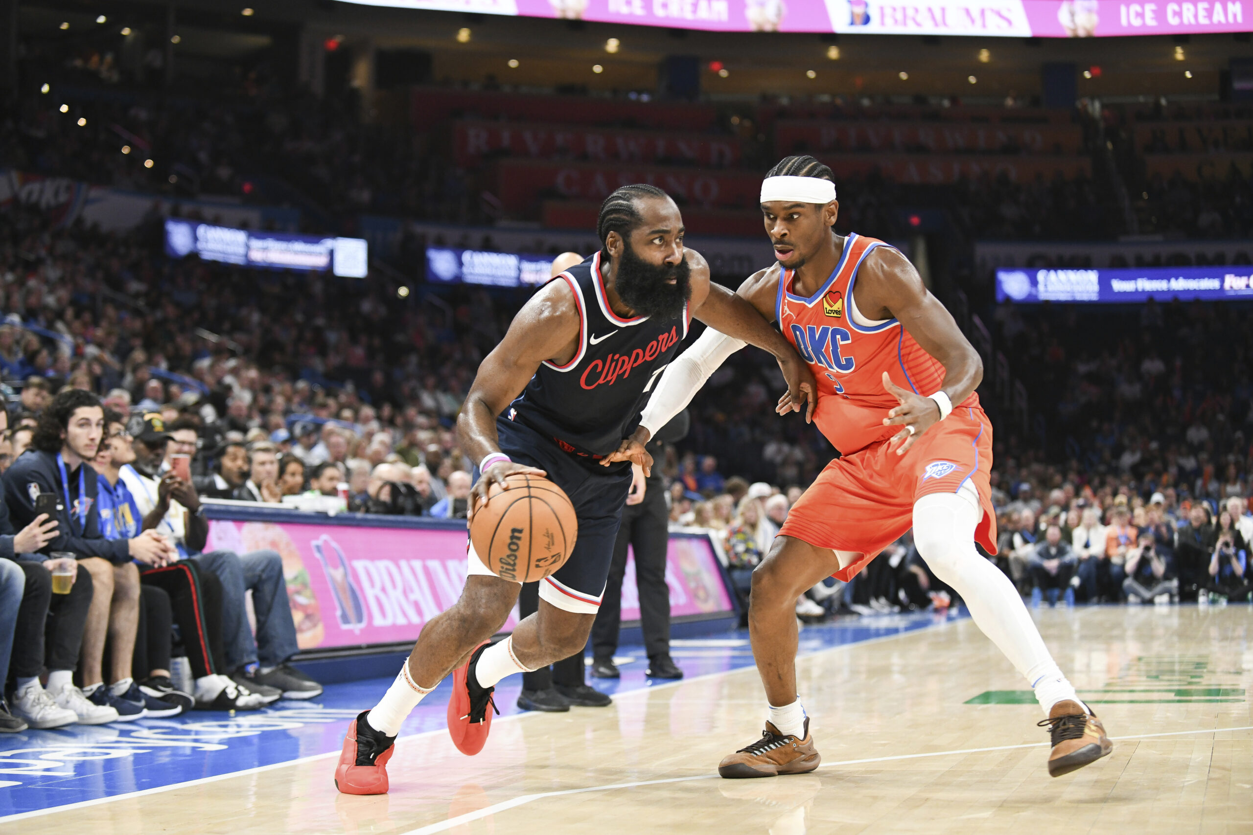 Clippers guard James Harden, left, pushes past Oklahoma City Thunder...