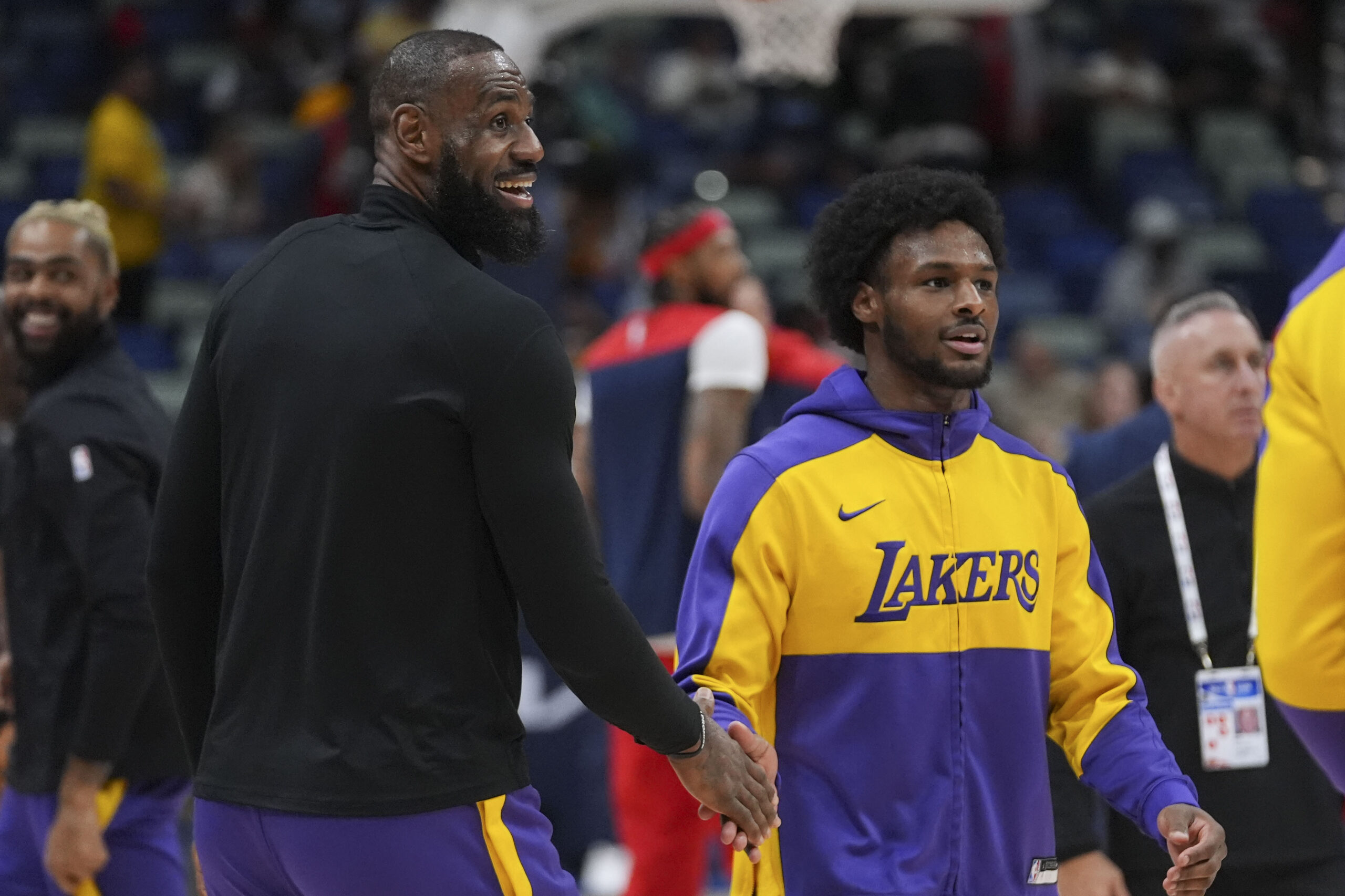 Lakers forward LeBron James greets his son guard Bronny James,...