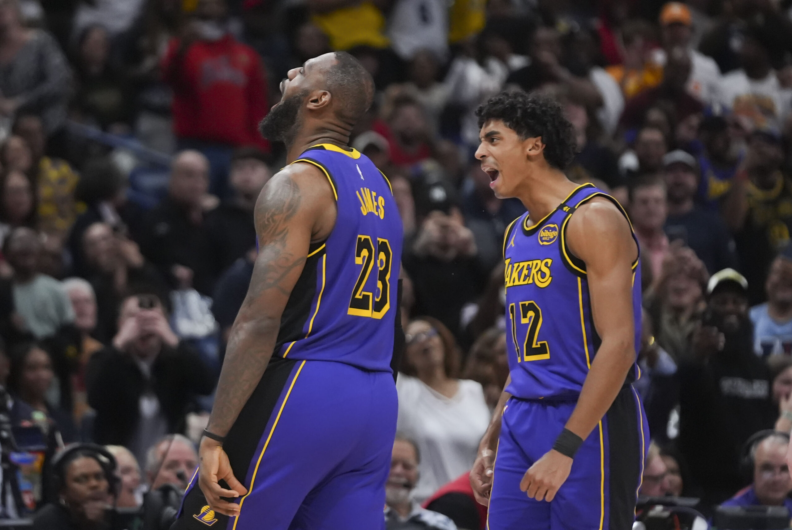 Lakers forward LeBron James (23) celebrates with guard Max Christie...