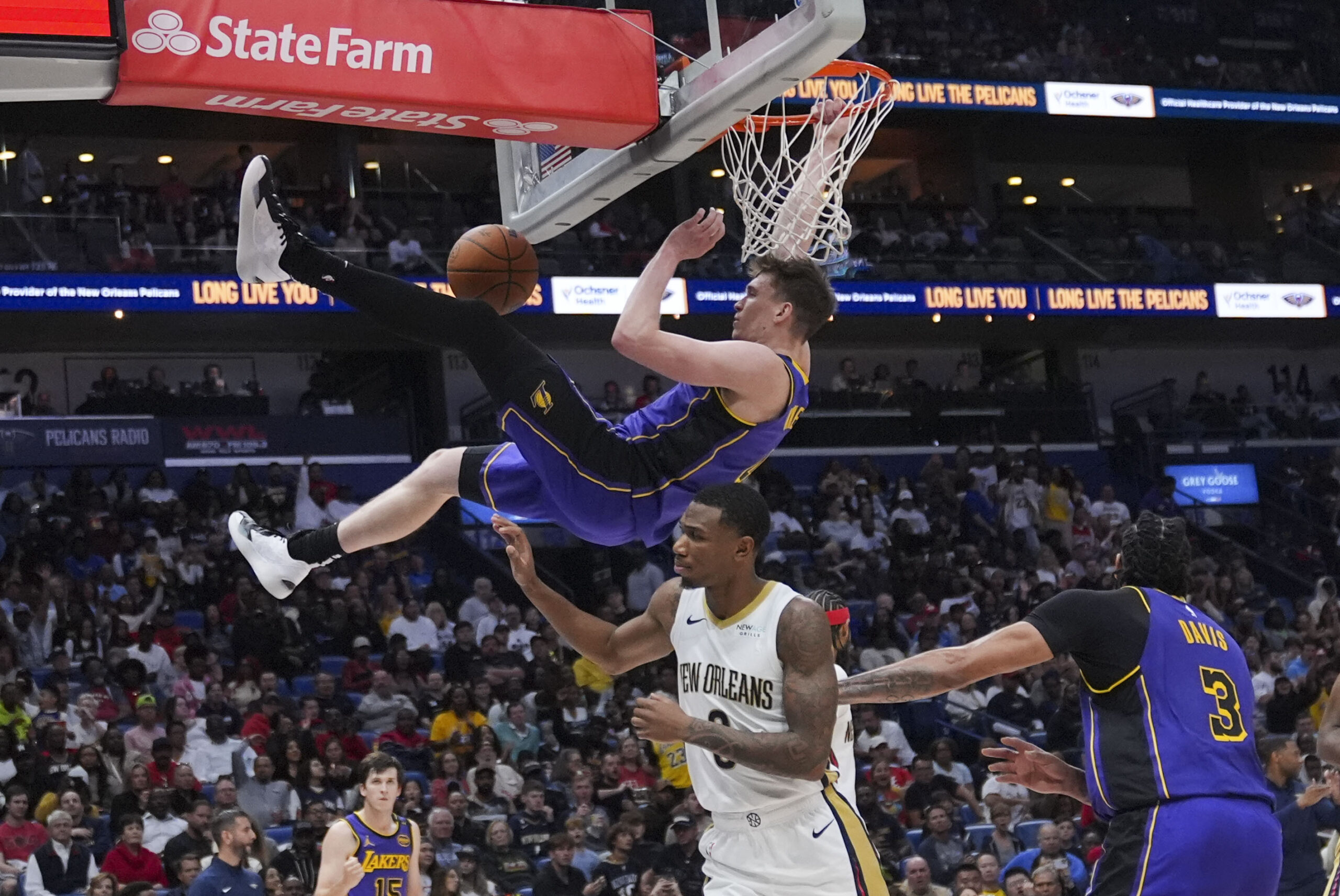 Lakers guard Dalton Knecht dunks over New Orleans Pelicans forward...