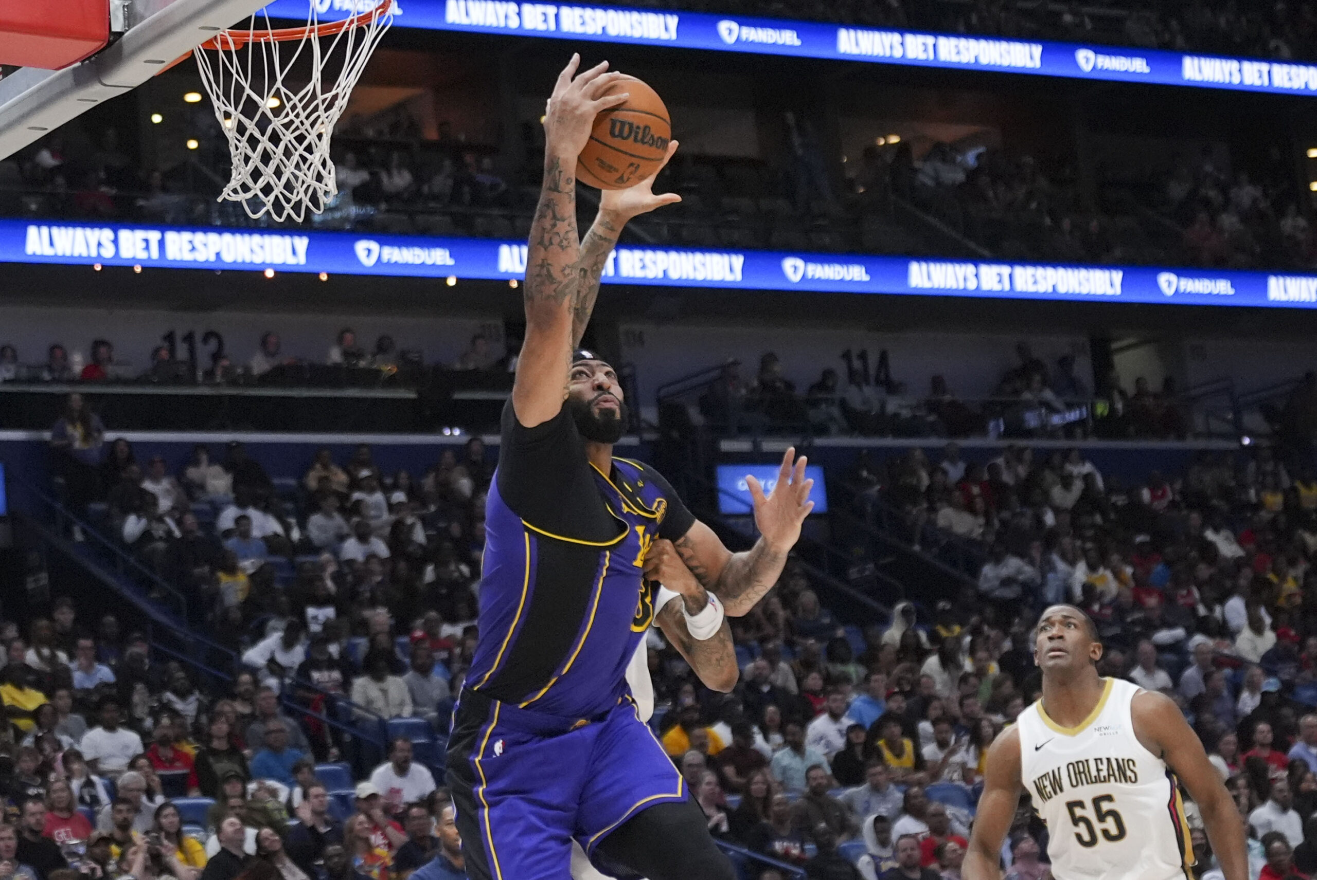 Lakers forward Anthony Davis battles under the basket in the...