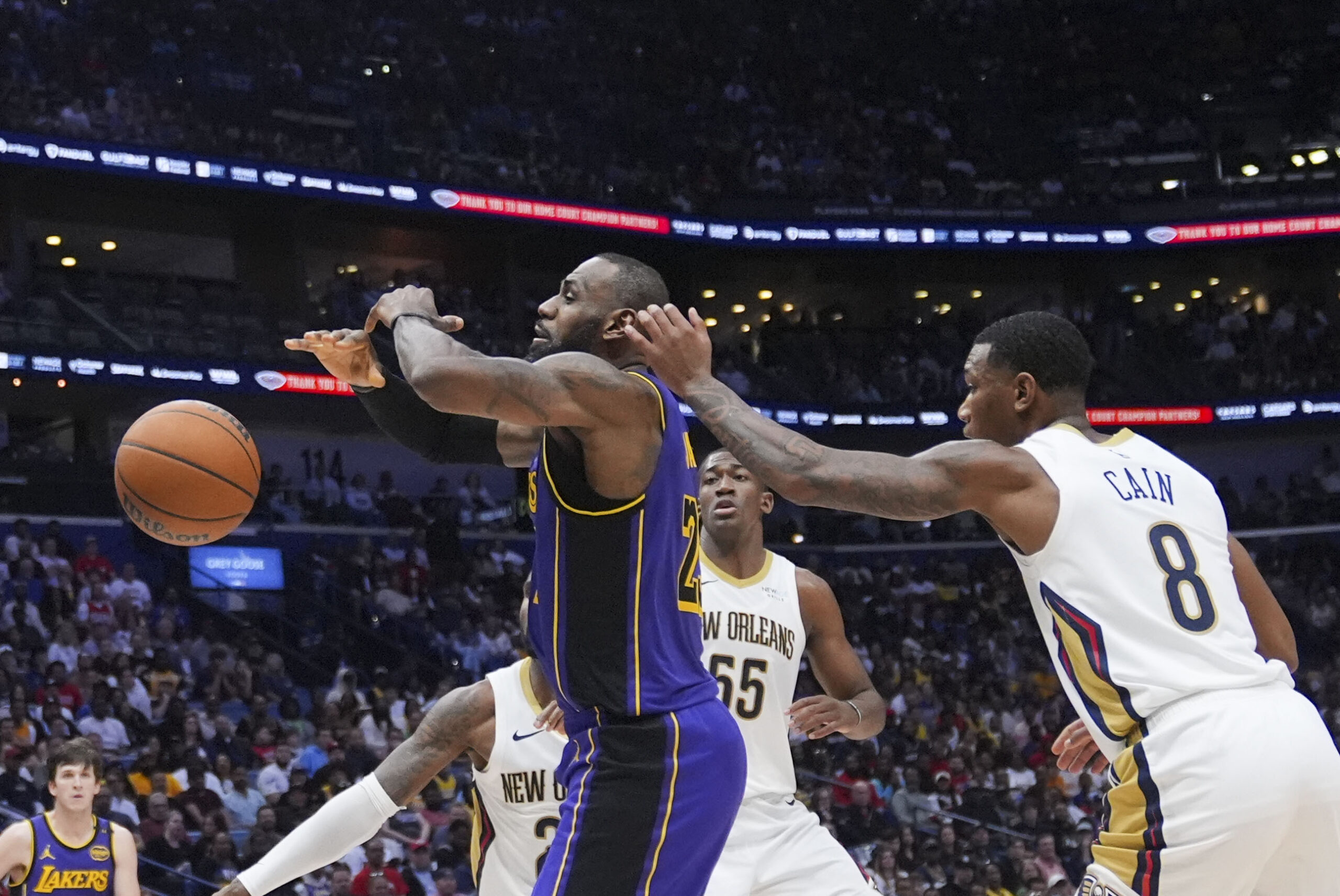 Lakers forward LeBron James loses the ball as he goes...