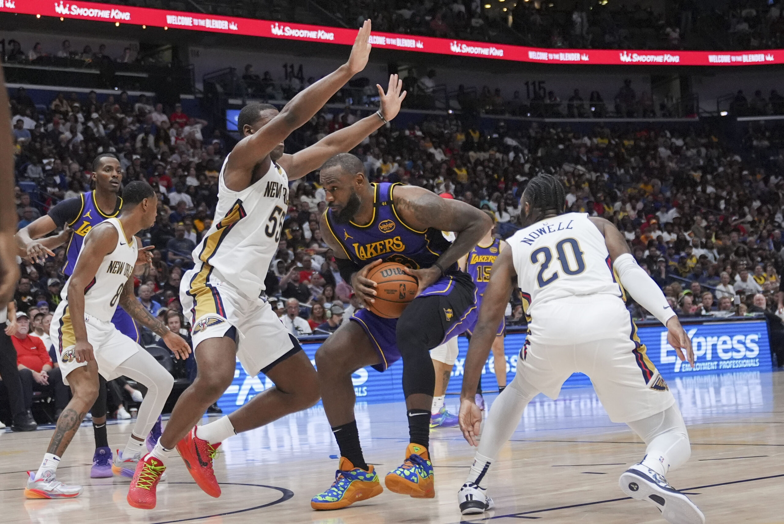 Lakers forward LeBron James drives to the basket between New...