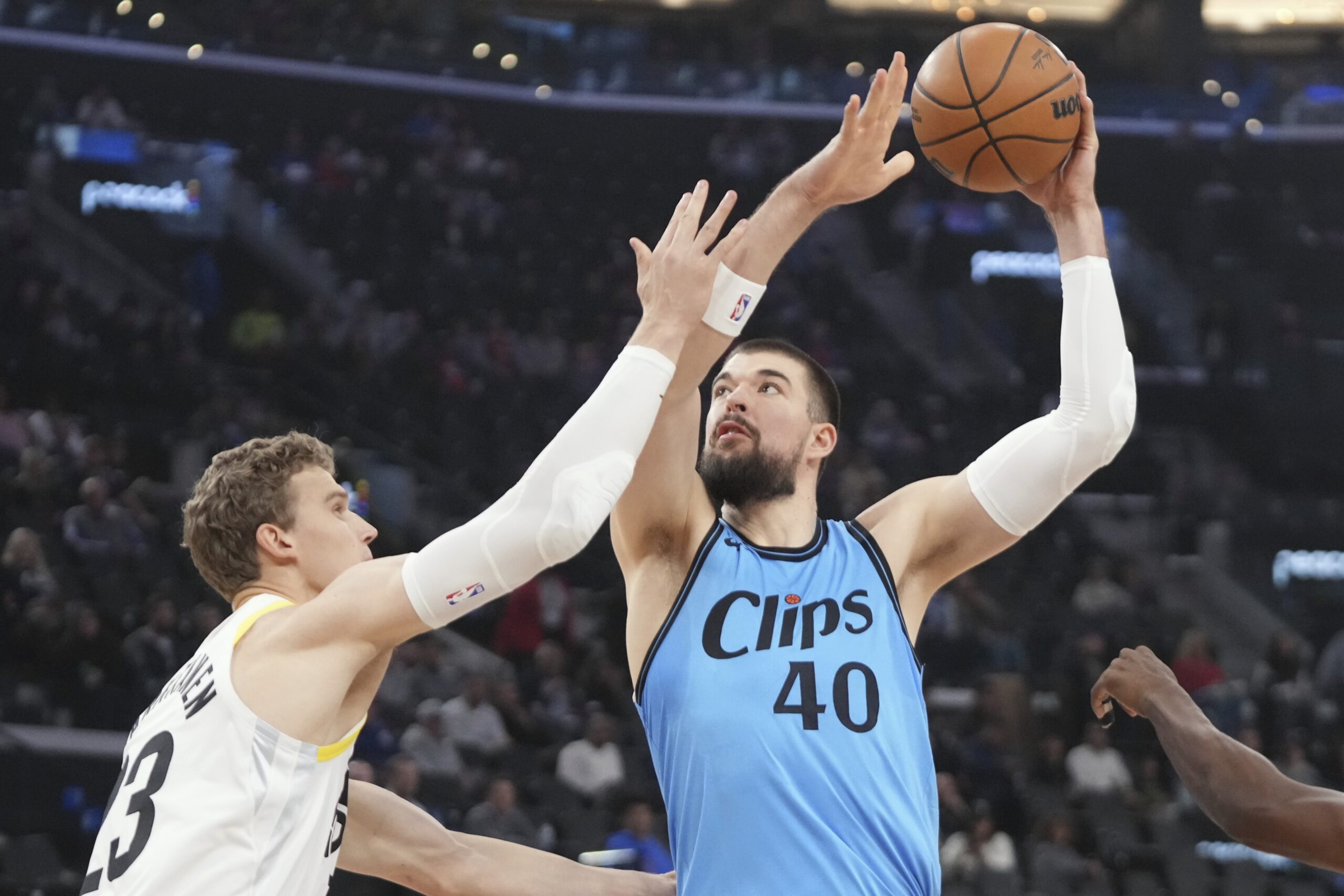 Clippers center Ivica Zubac, right, shoots as Utah Jazz forward...