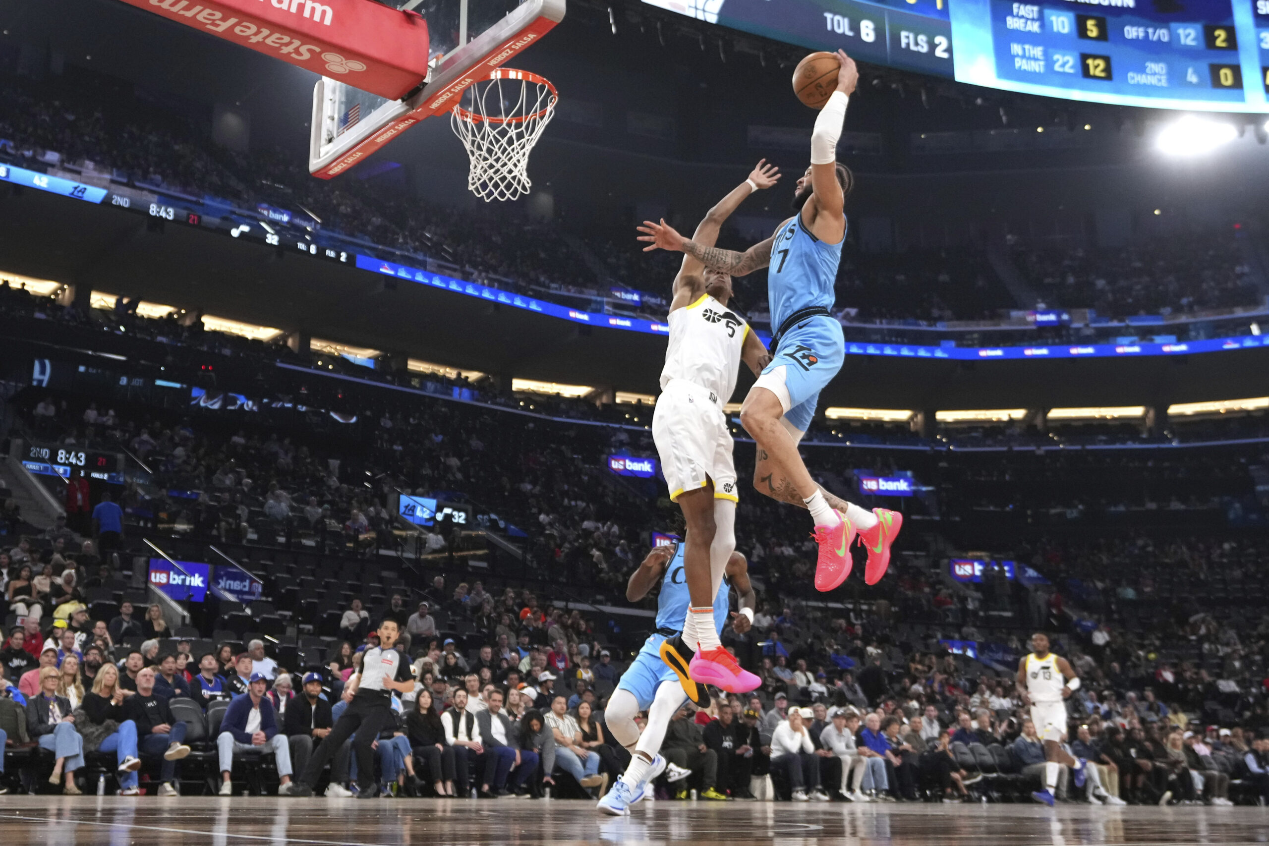 Clippers guard Amir Coffey, right, goes up for a dunk...