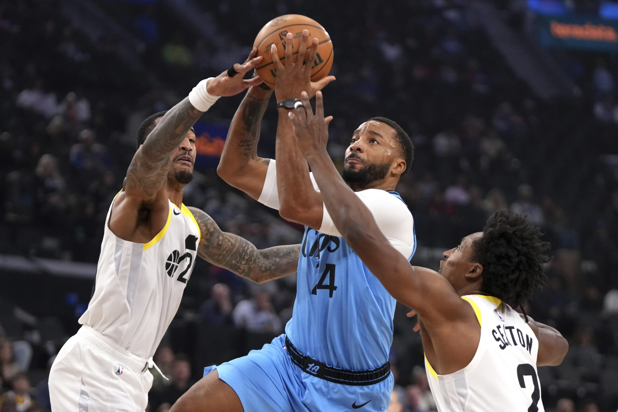 Clippers guard Norman Powell, center, shoots as Utah Jazz forward...