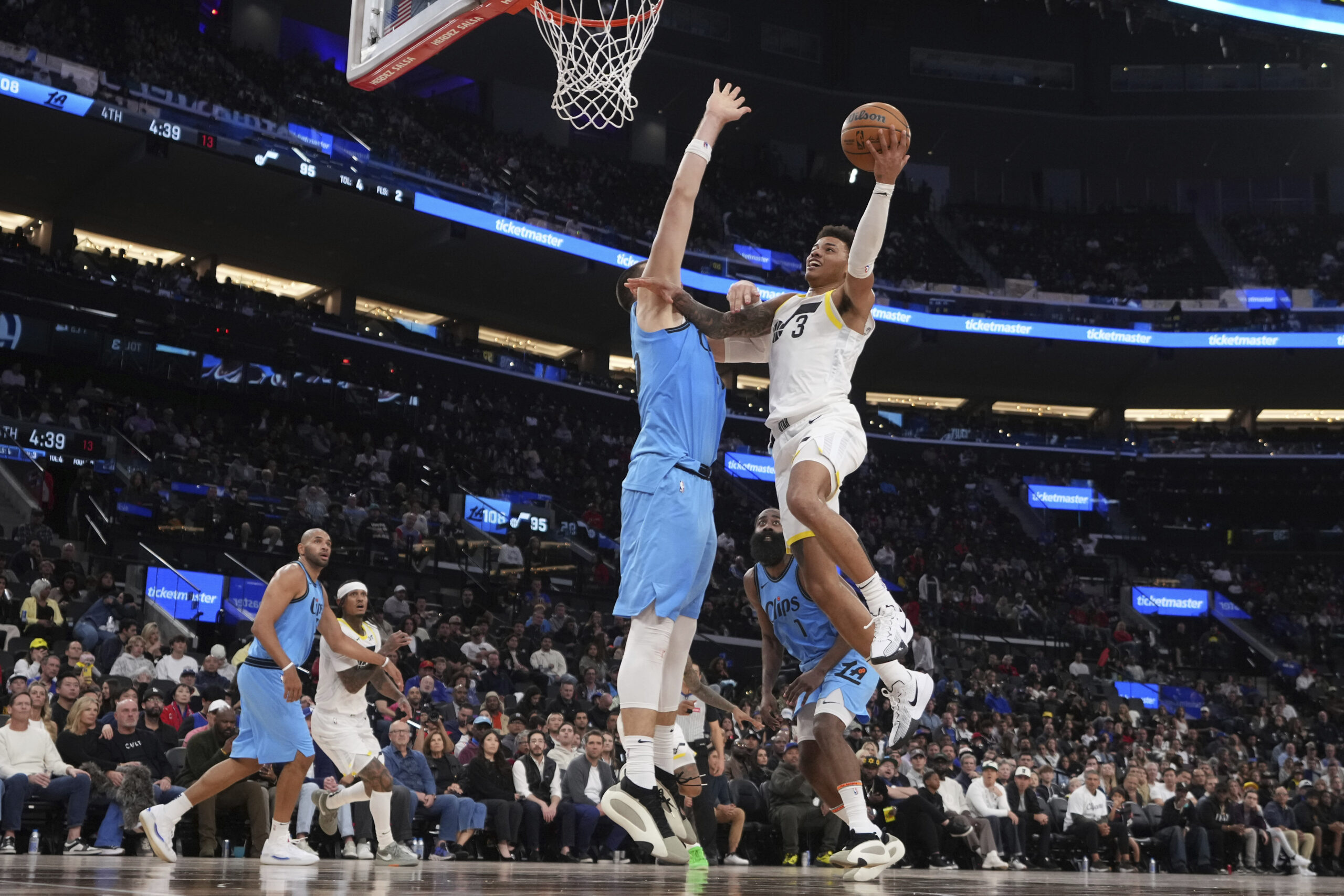 Utah Jazz guard Keyonte George, right, shoots as Clippers center...