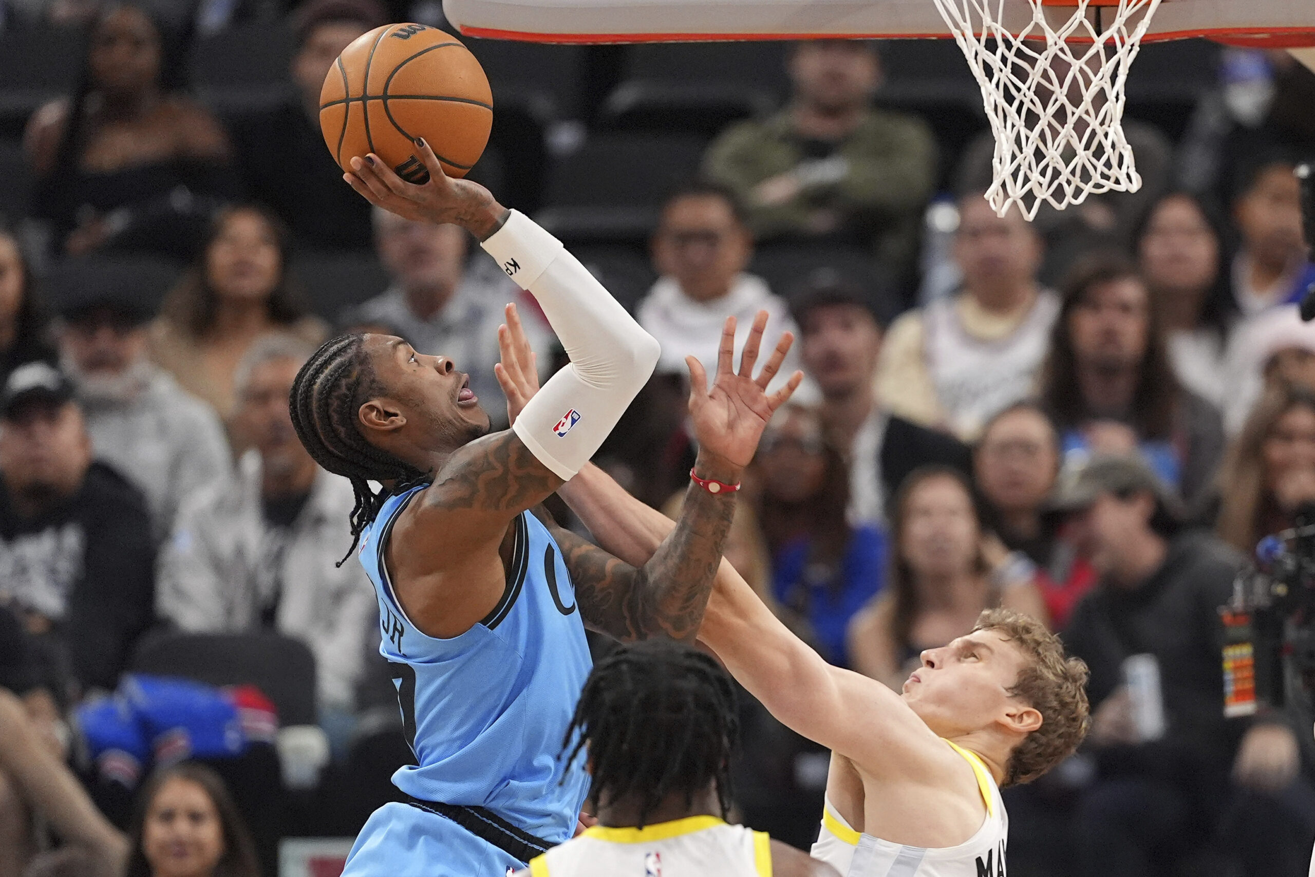 Clippers guard Kevin Porter Jr., left, shoots as Utah Jazz...