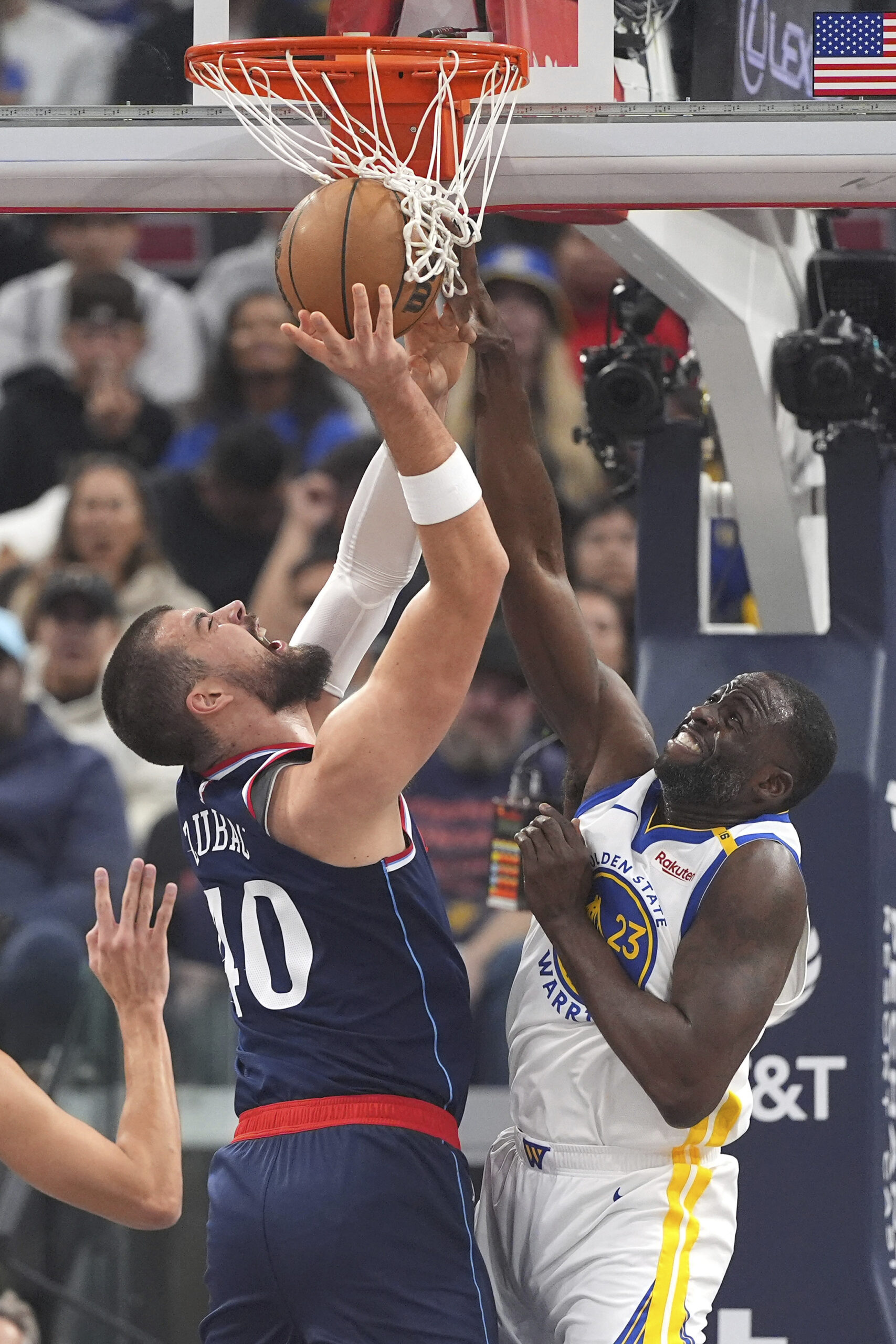 Clippers center Ivica Zubac, left, shoots as Golden State Warriors...