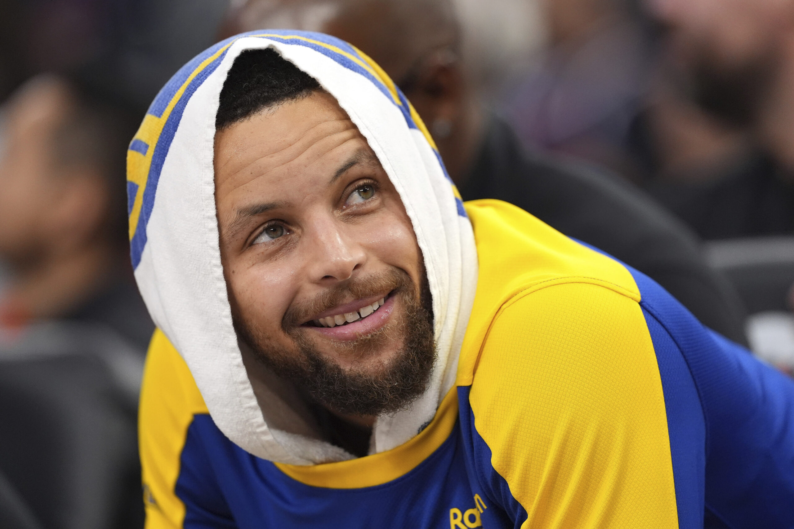 Golden State Warriors guard Steph Curry watches from the bench...