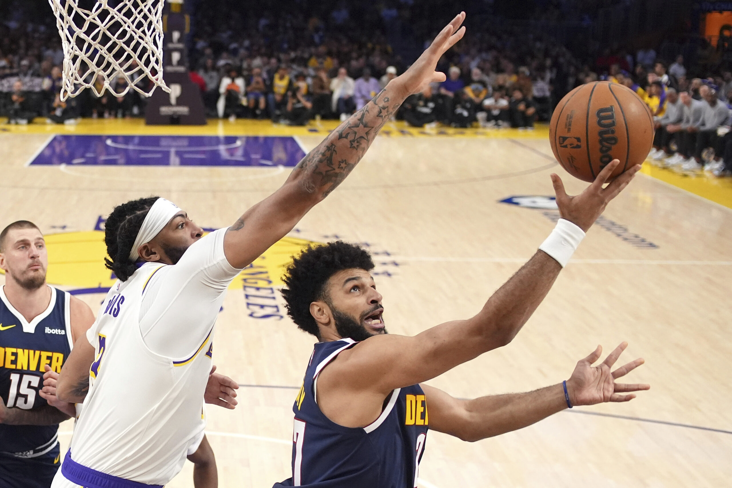 Denver Nuggets guard Jamal Murray, right, shoots as Lakers forward...