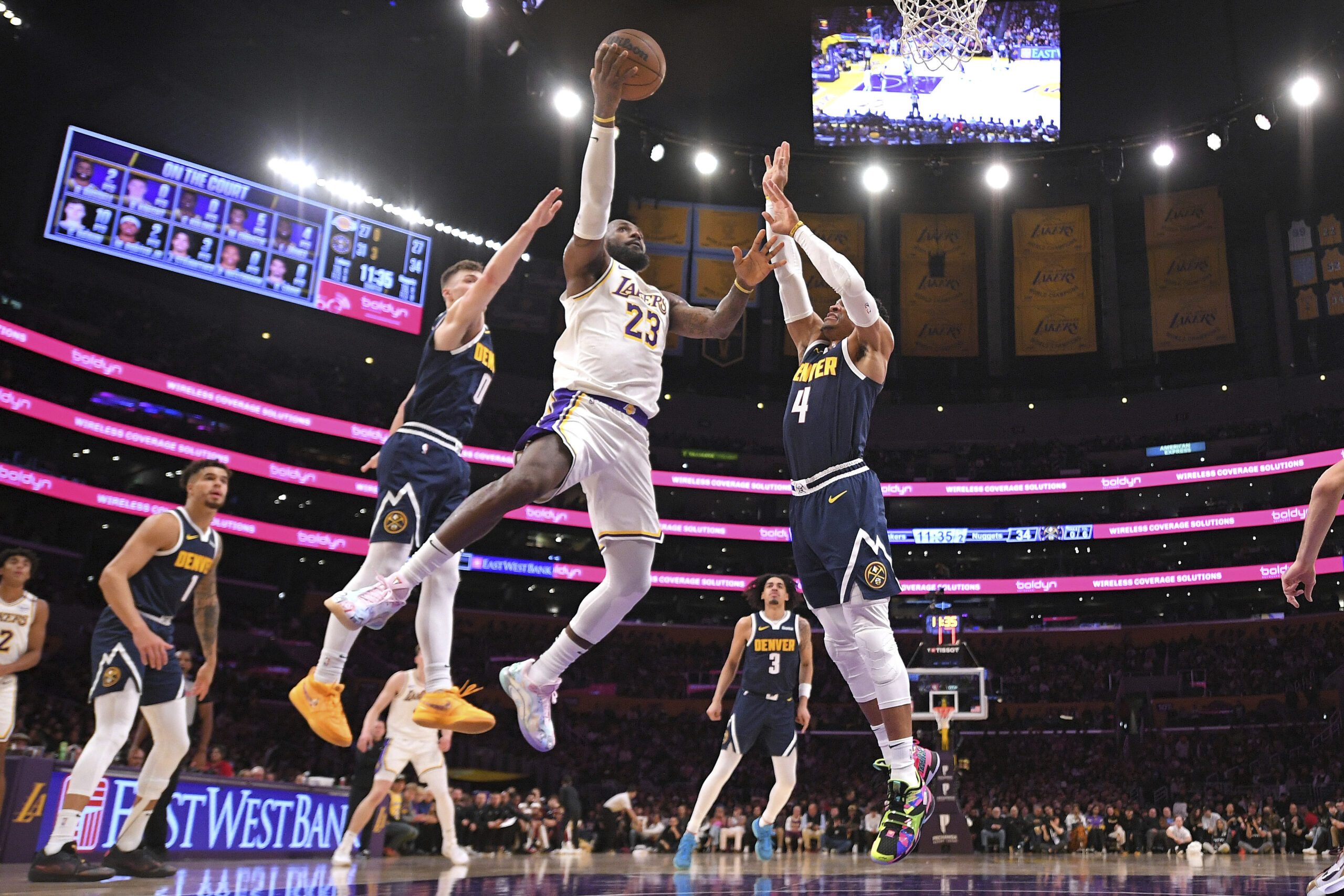 Lakers forward LeBron James (23) shoots as Denver Nuggets guard...