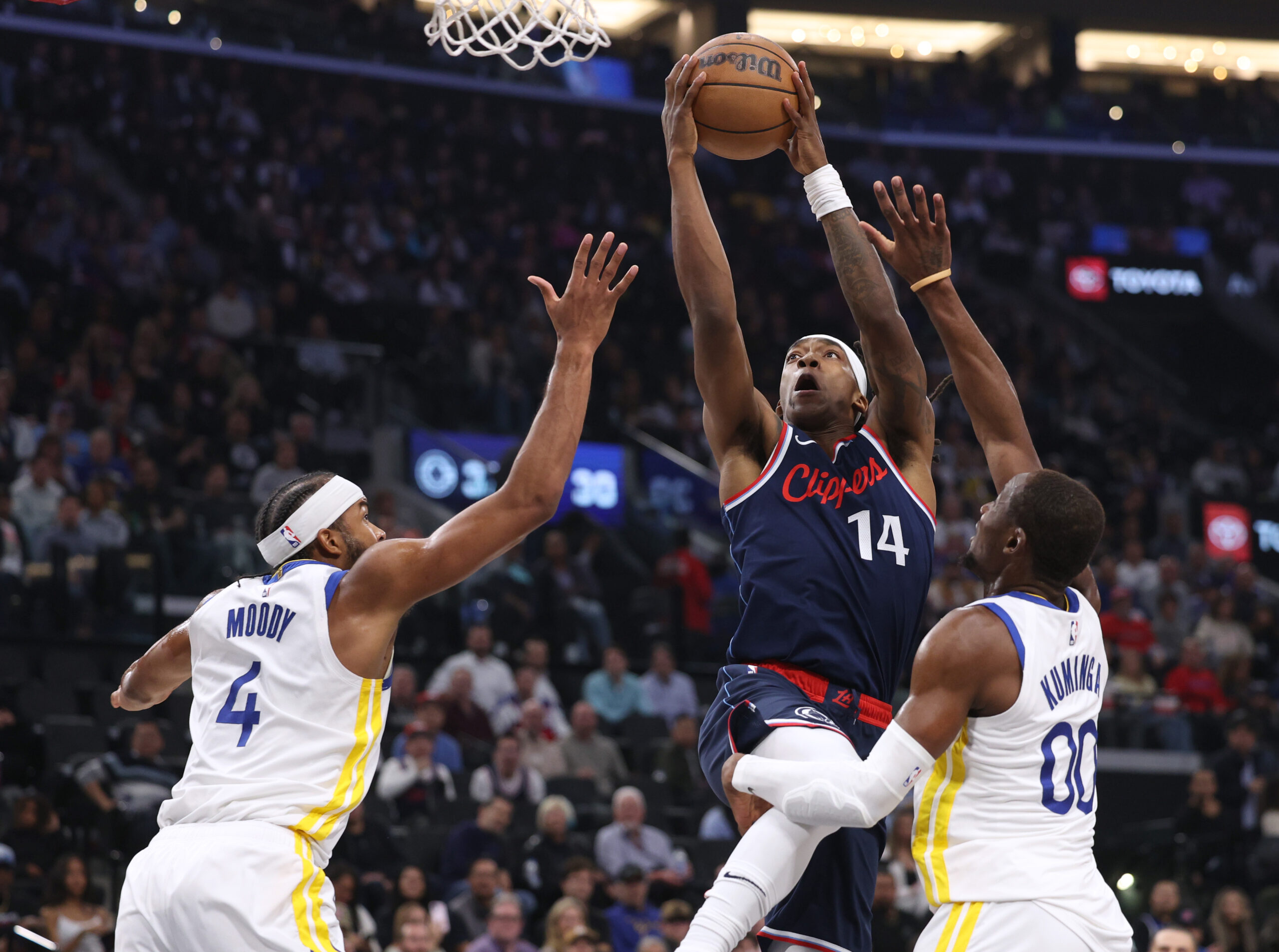 Clippers guard Terance Mann drives to the basket between the...