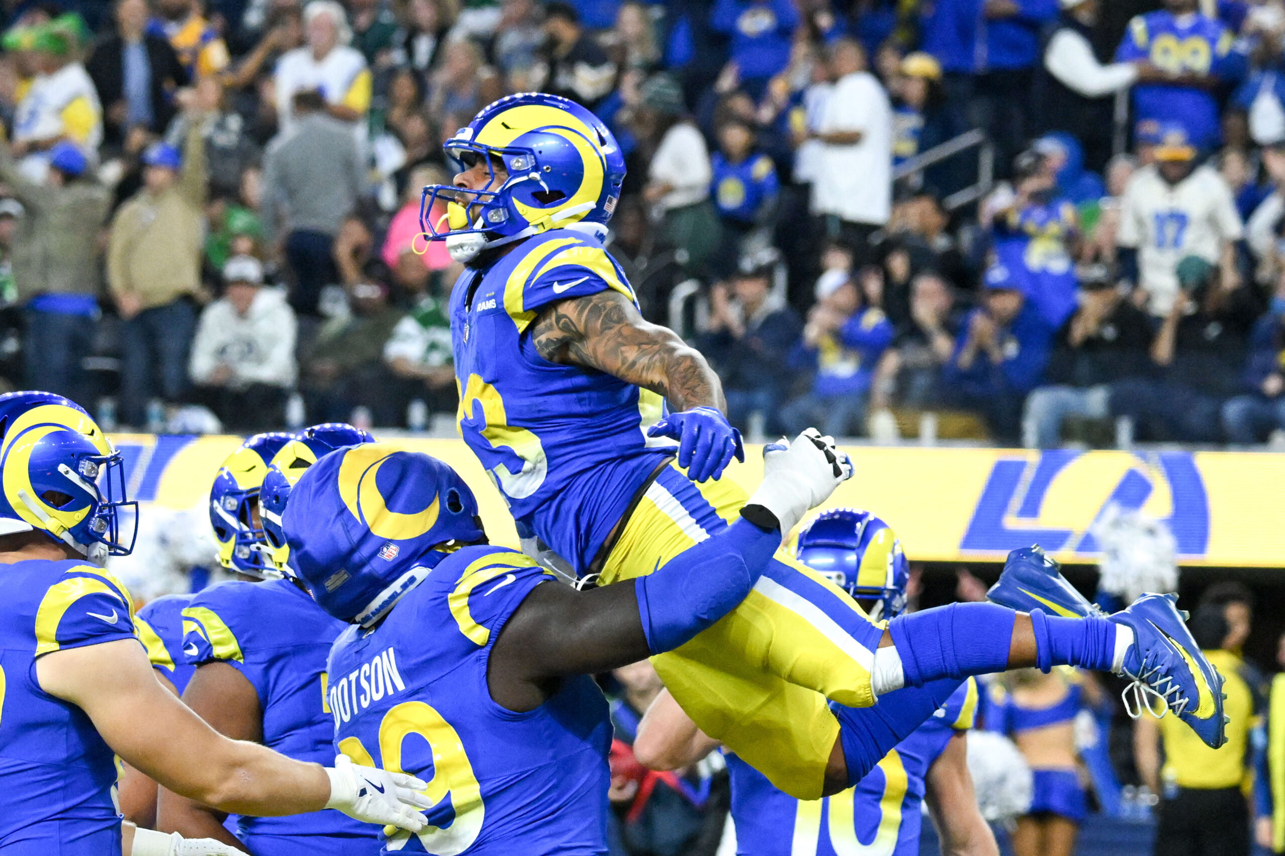 Rams Kevin Dotson, #69, hoists Kyren Williams, #23, in the...