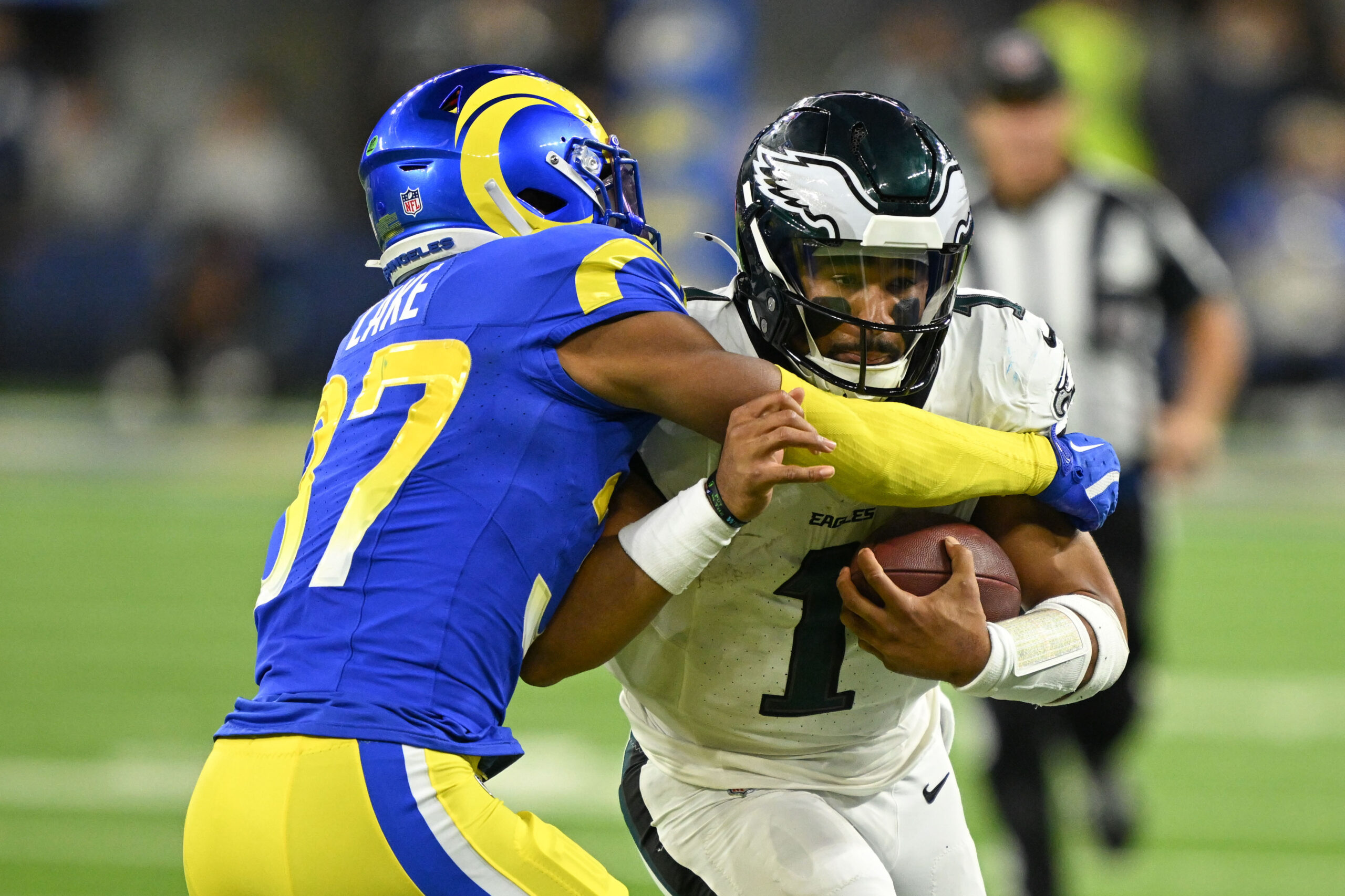 Rams Quentin Lake, #37, wraps up Eagles QB Jalen Hurts,...