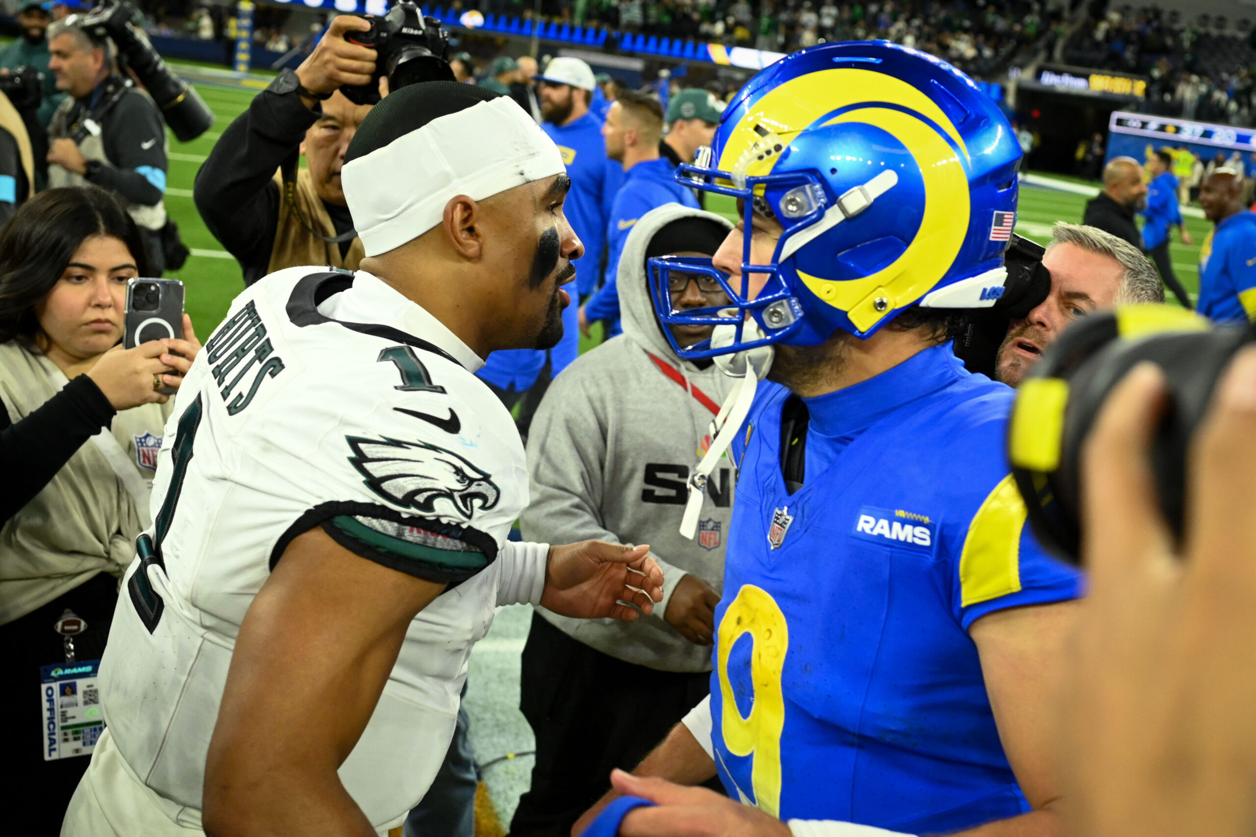 Eagles QB Jalen Hurts, #1, greets Rams QB Matthew Stafford,...