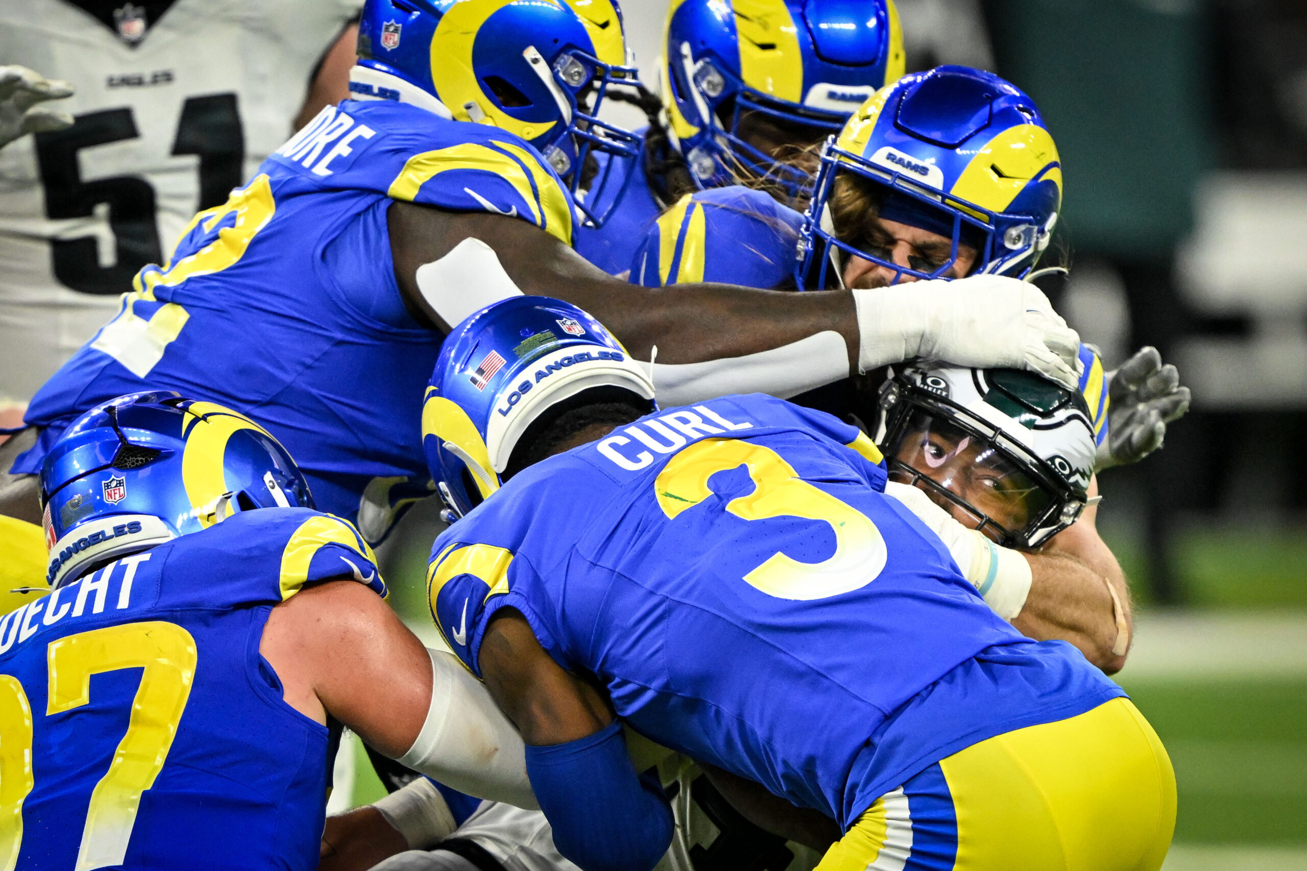 Eagles Kenneth Gainwell, #14, is swarmed by Rams defenders during...