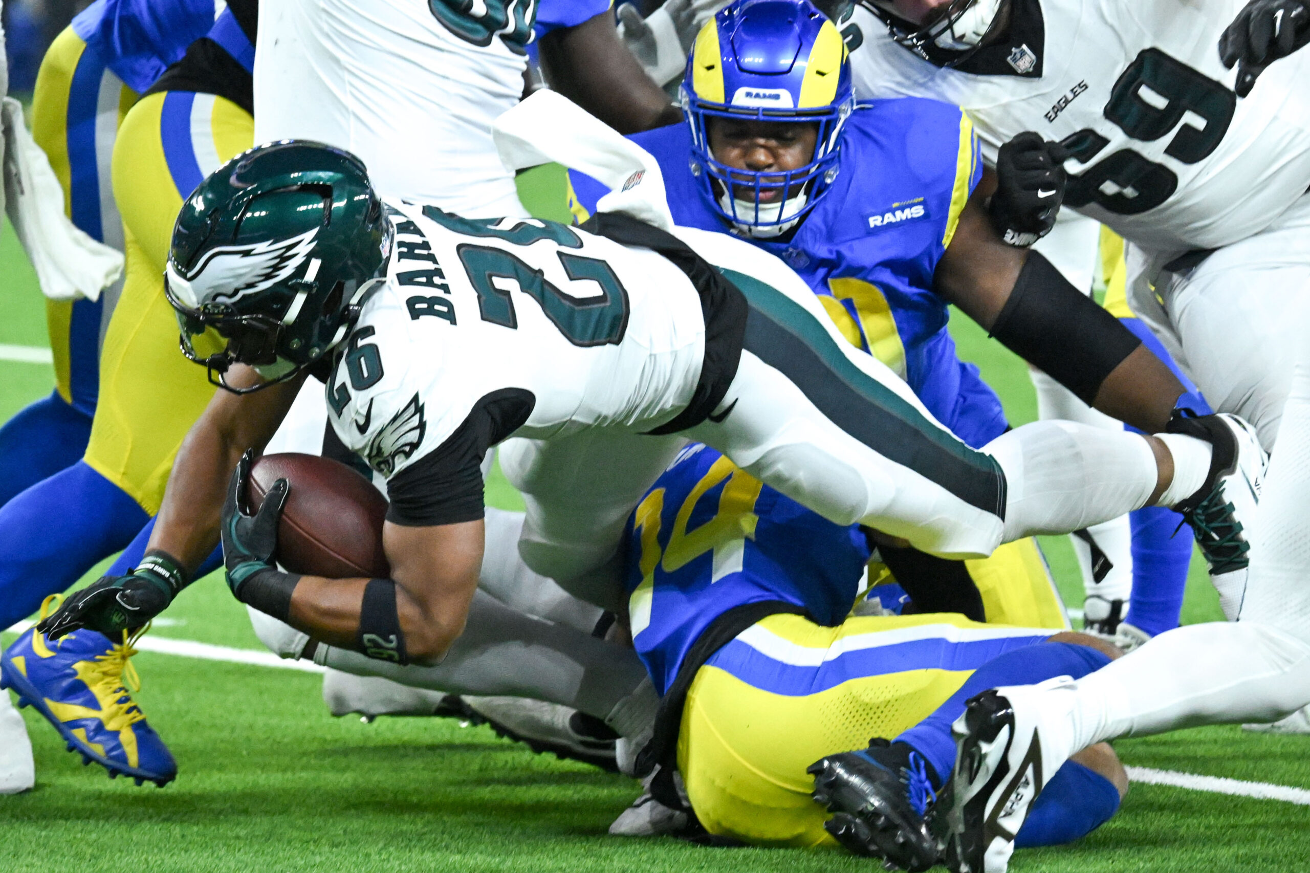 Eagles Saquon Barkley, #26, dives for yardage during first quarter...