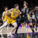 Jan 30, 2024; Atlanta, Georgia, USA; Los Angeles Lakers guard Austin Reaves (15) works against the defense of Atlanta Hawks guard Trae Young (11) during the first half at State Farm Arena. Mandatory Credit: Dale Zanine-USA TODAY Sports