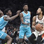 Nov 21, 2024; Charlotte, North Carolina, USA; Detroit Pistons guard Cade Cunningham (2) looks to shoot through the defense of the Charlotte Hornets during the first half at the Spectrum Center. Mandatory Credit: Sam Sharpe-Imagn Images