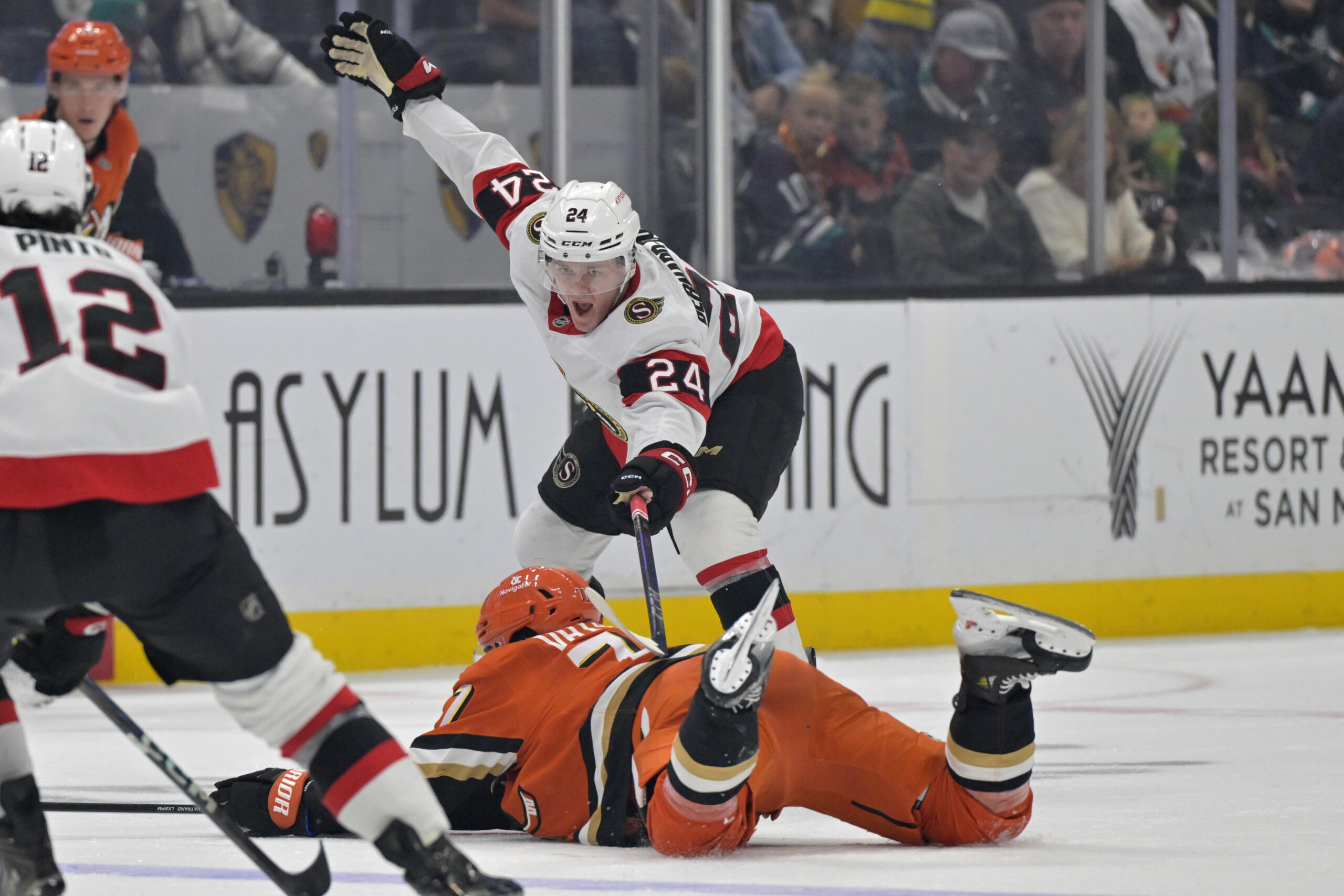 Ducks right wing Frank Vatrano is tripped up by Ottawa...