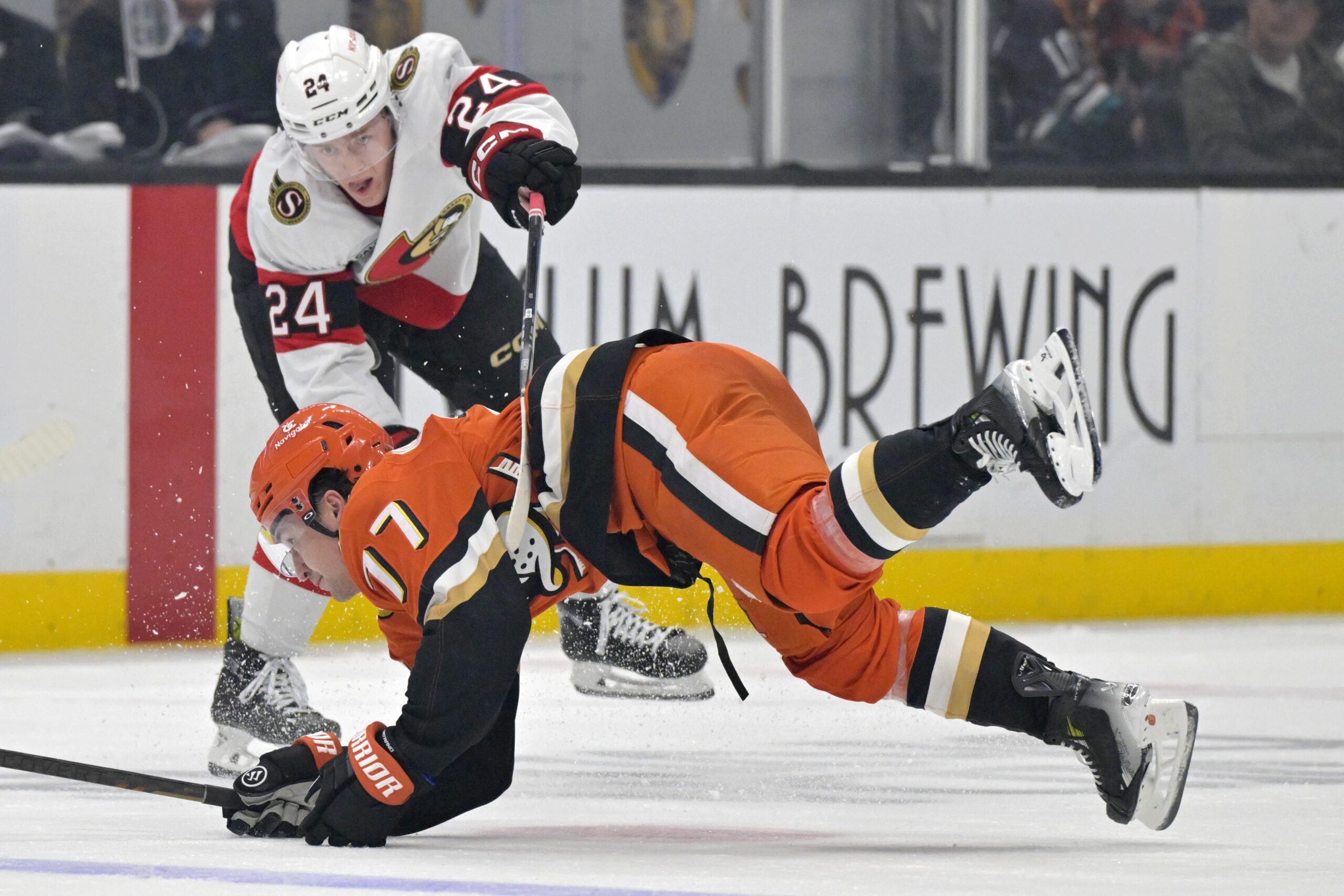 Ducks right wing Frank Vatrano is tripped up by Ottawa...