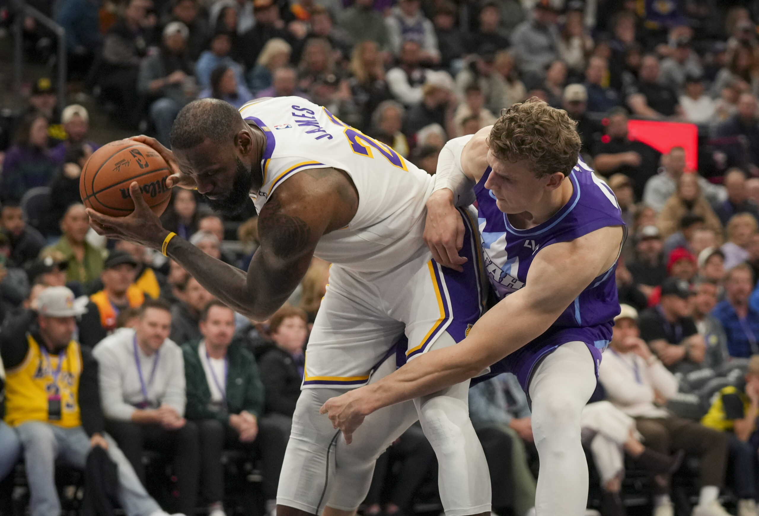 Lakers forward LeBron James (23) keeps the ball away from...