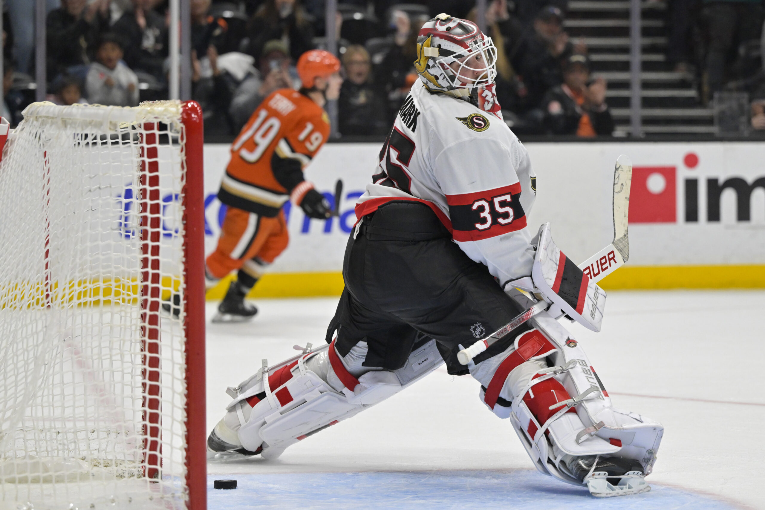 Ottawa Senators goaltender Linus Ullmark watches as the puck lands...