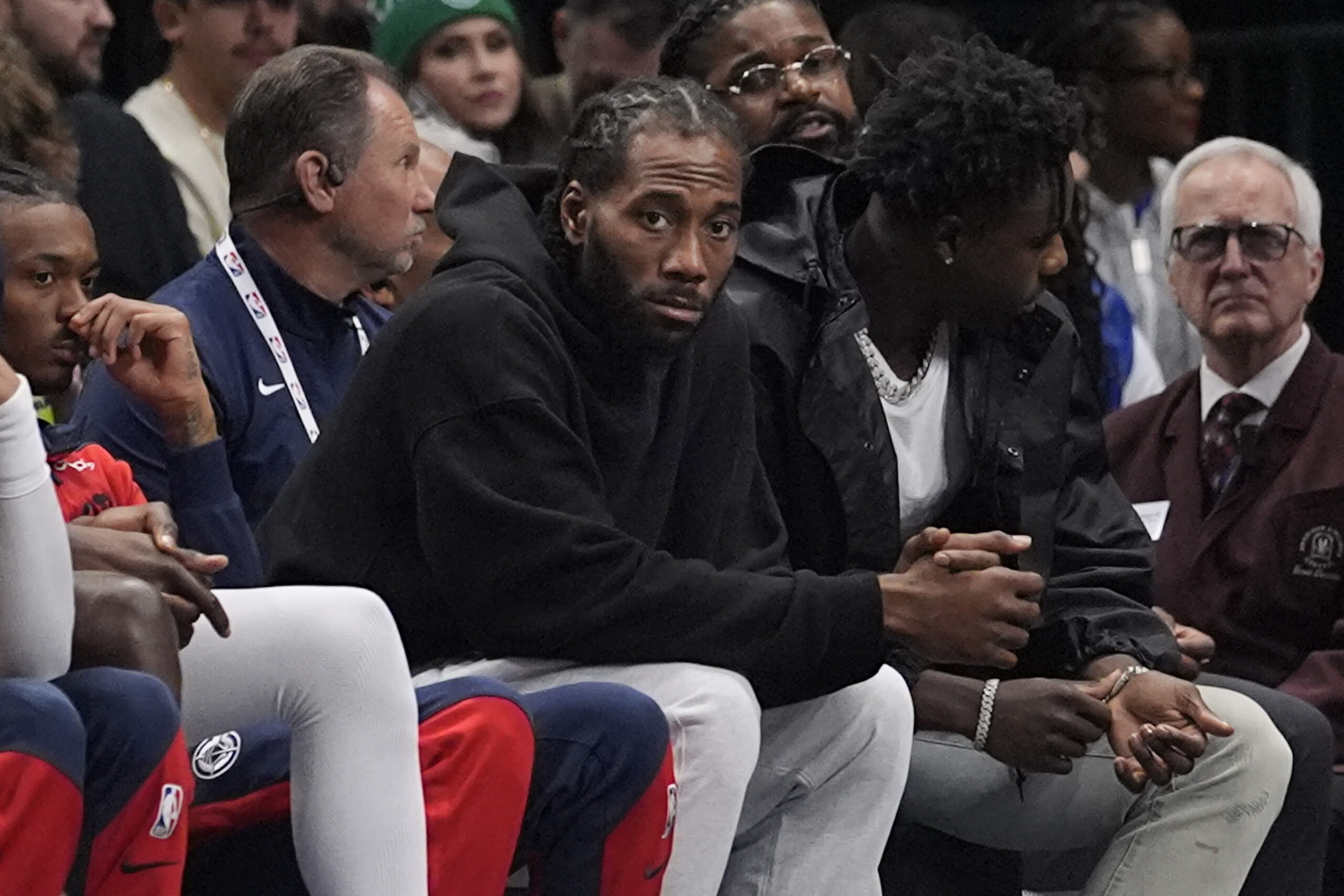 Clippers forward Kawhi Leonard watches from the bench during the...