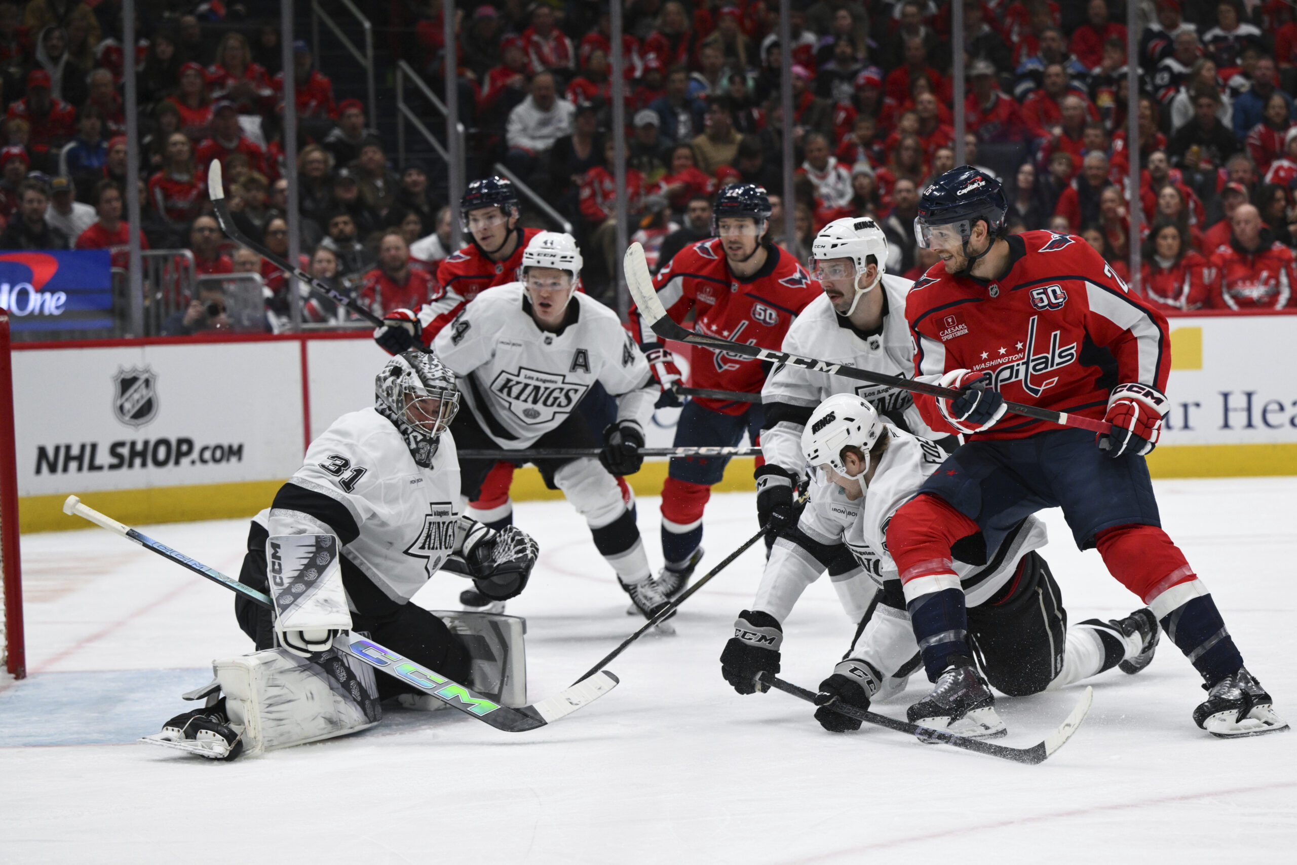 Washington Capitals center Nic Dowd, right attempts a shot as...