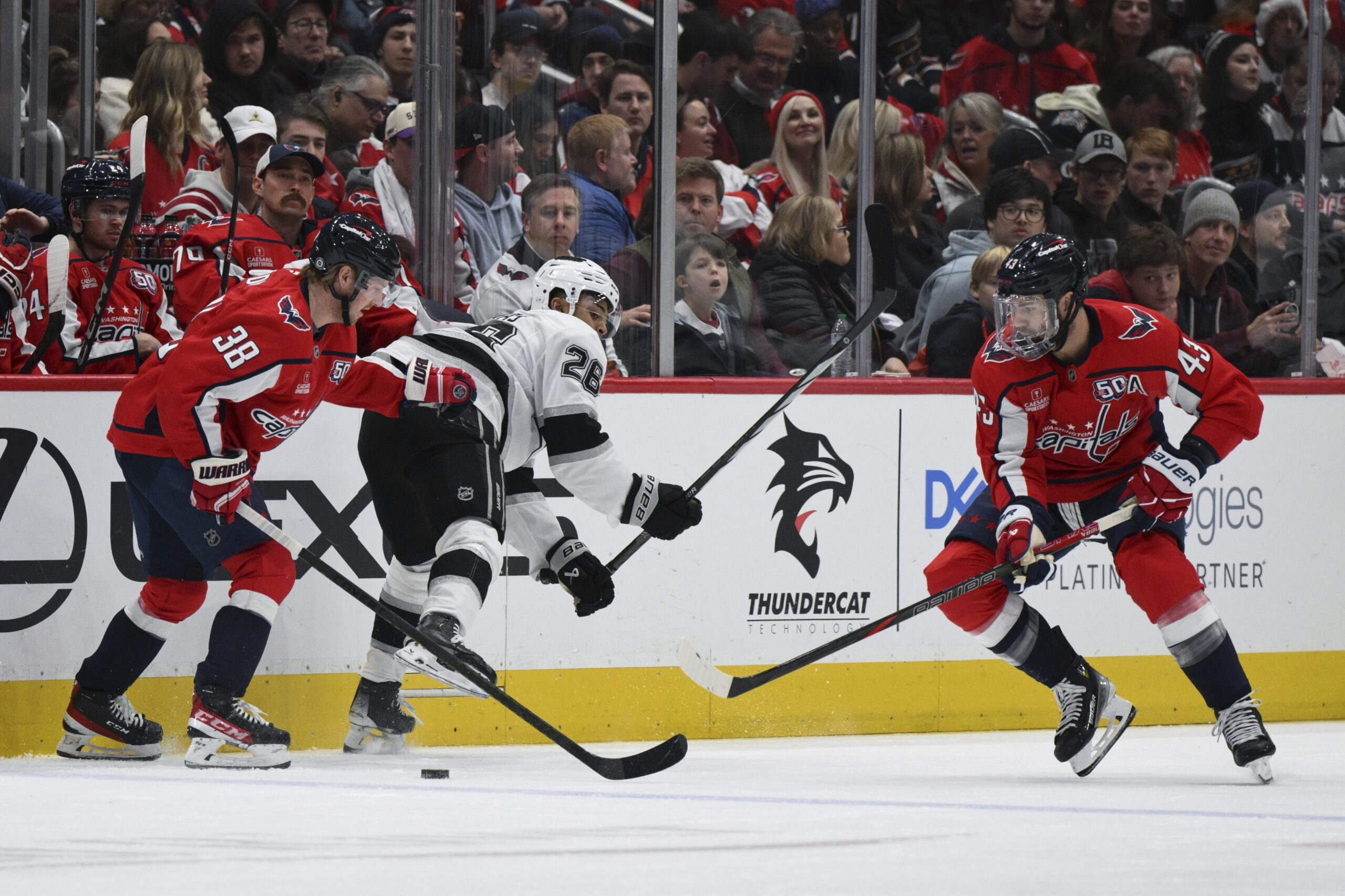 Kings center Akil Thomas (26) has the puck stolen from...