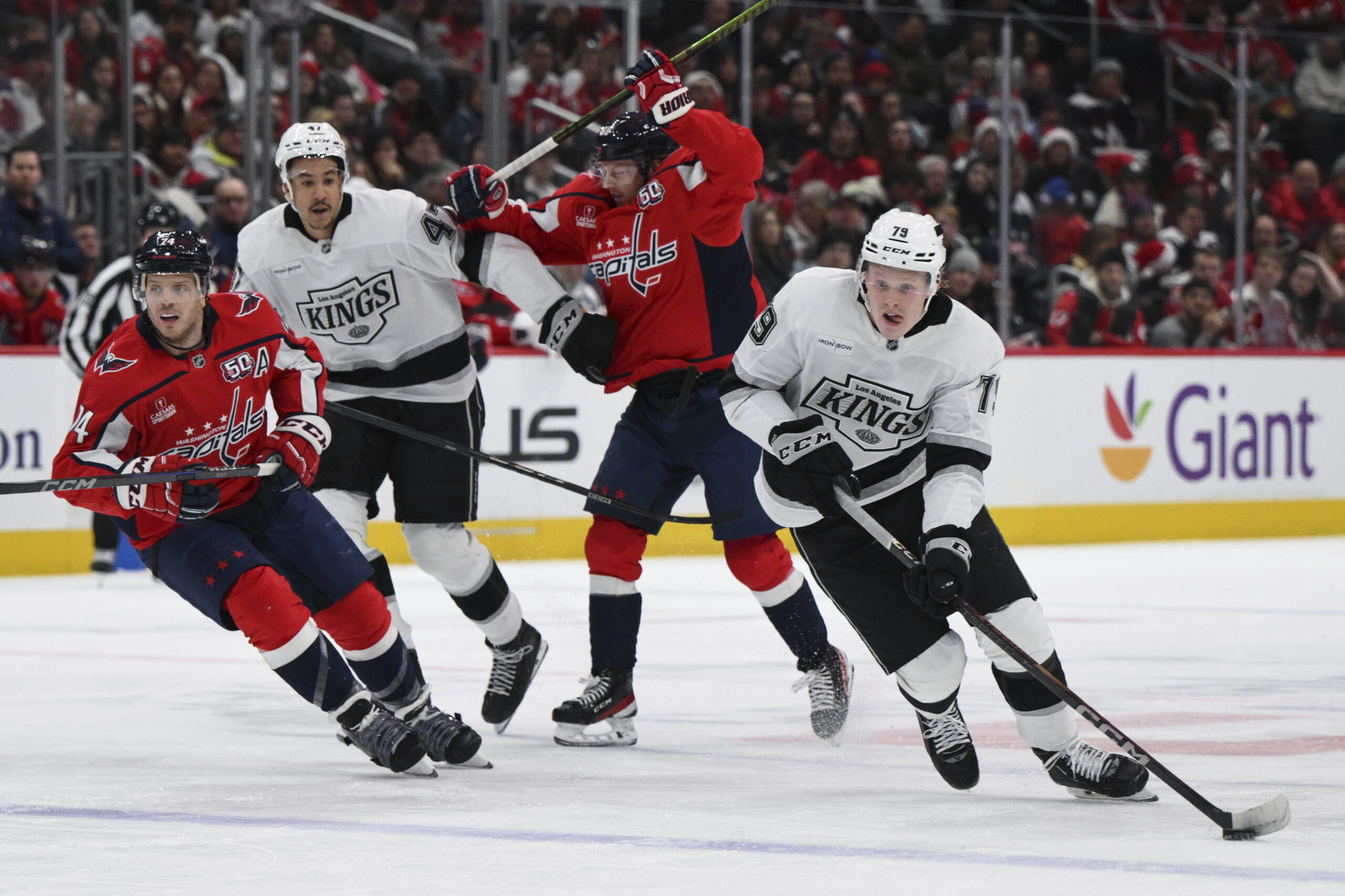 Kings center Samuel Helenius, right, handles the puck during the...