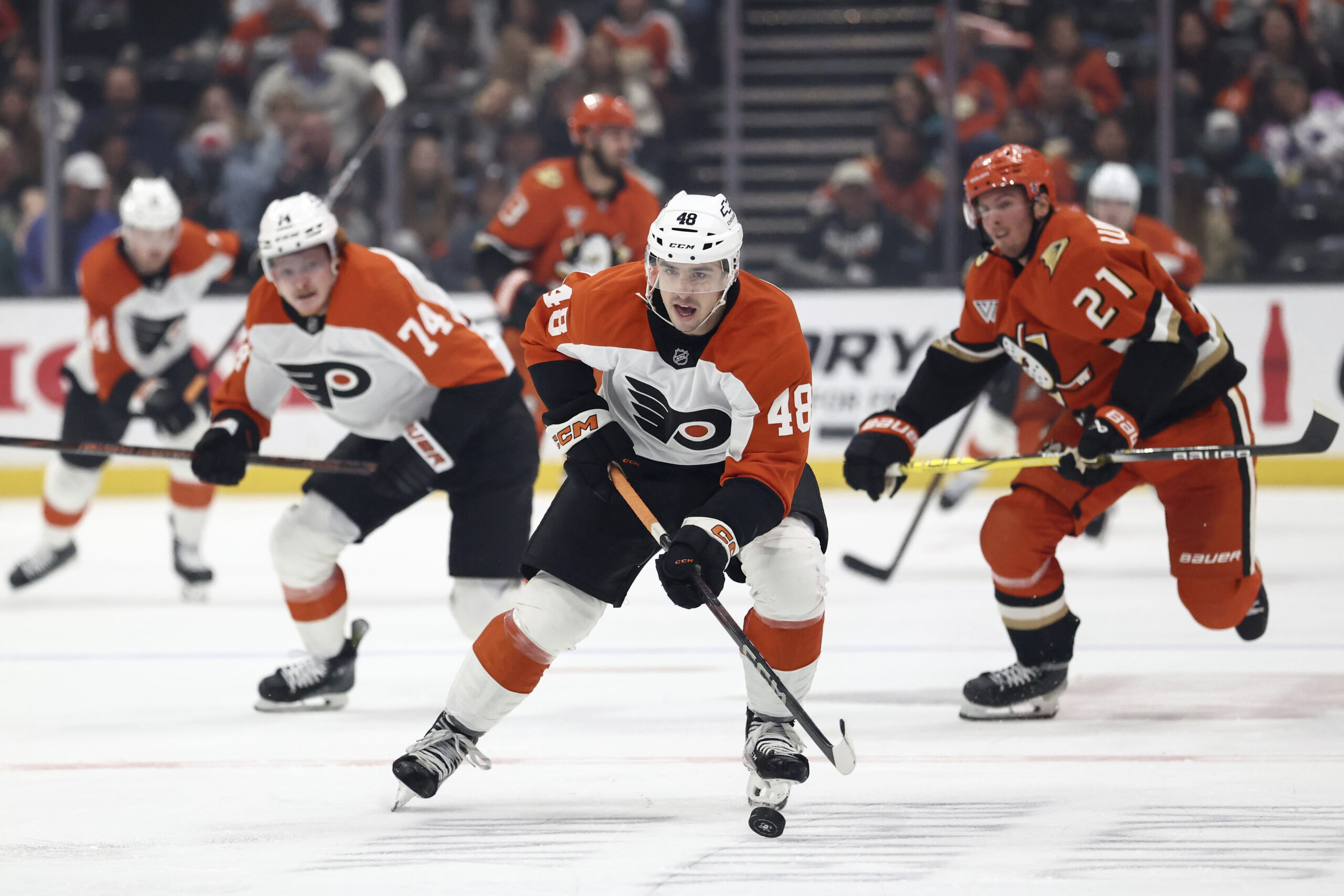 Philadelphia Flyers center Morgan Frost (48) brings the puck upice...