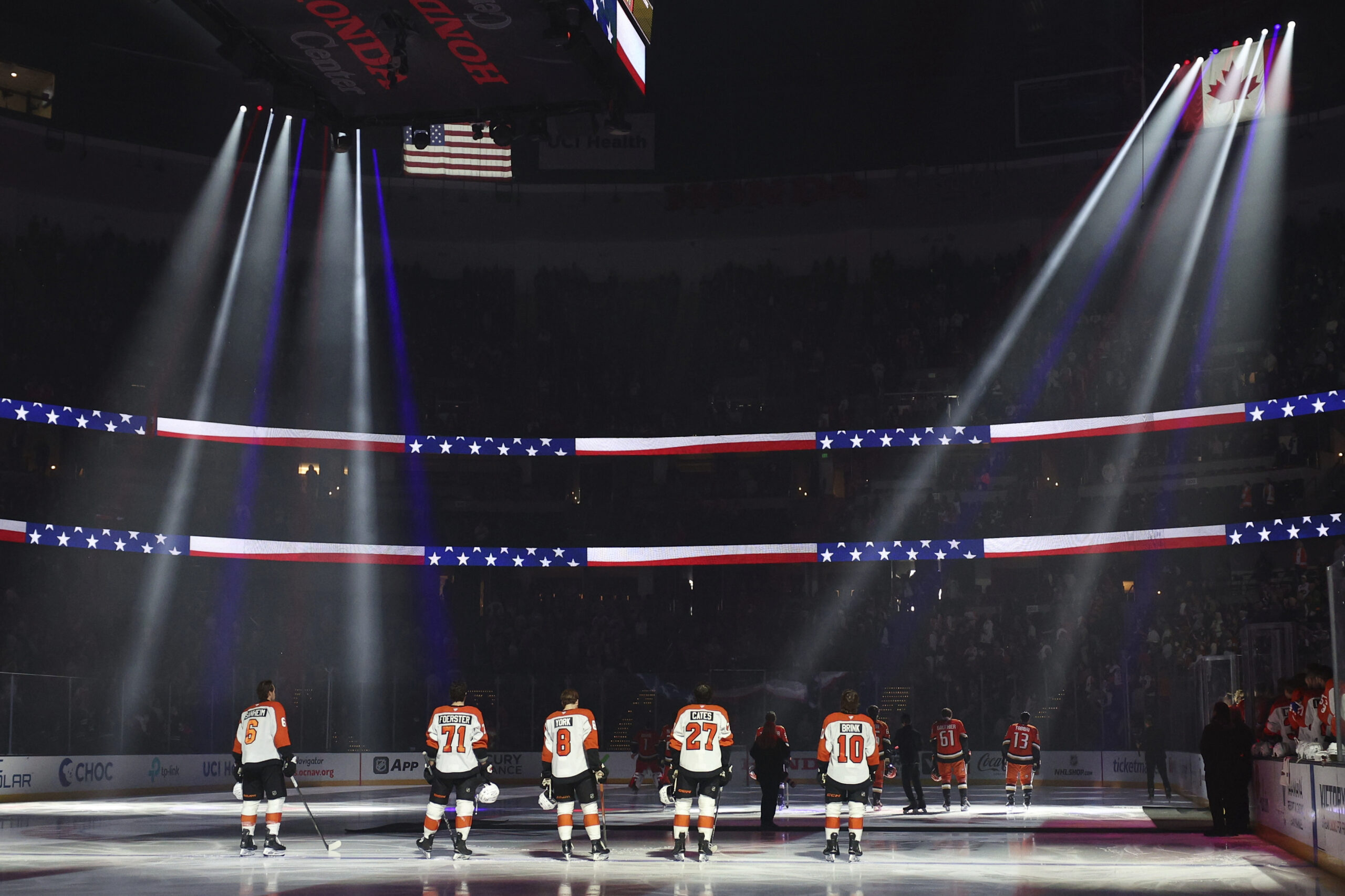 Members of the Philadelphia Flyers stand during the national anthem...