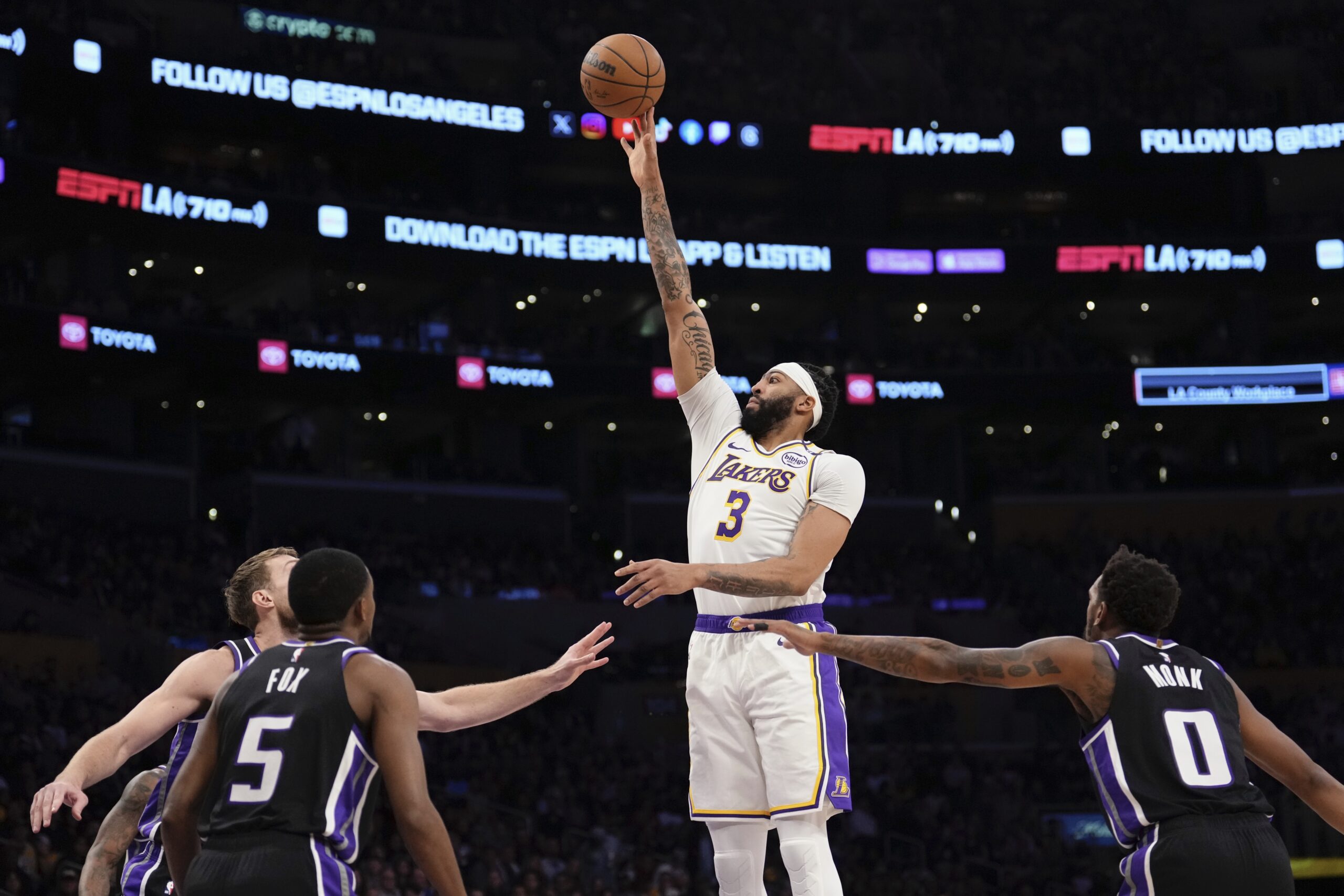 Lakers forward Anthony Davis, second from right, shoots as Sacramento...