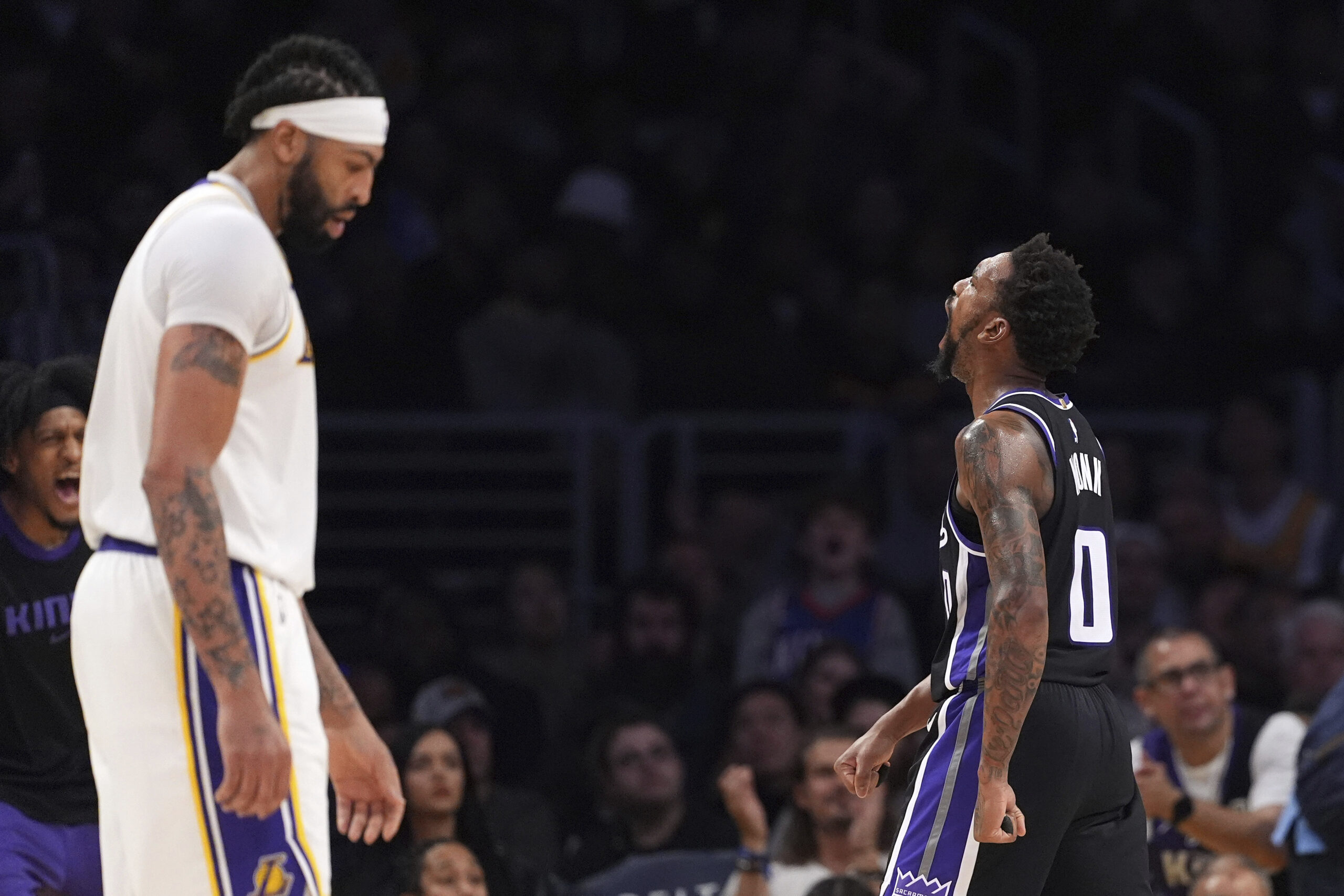 Sacramento Kings guard Malik Monk, right, celebrates after scoring as...