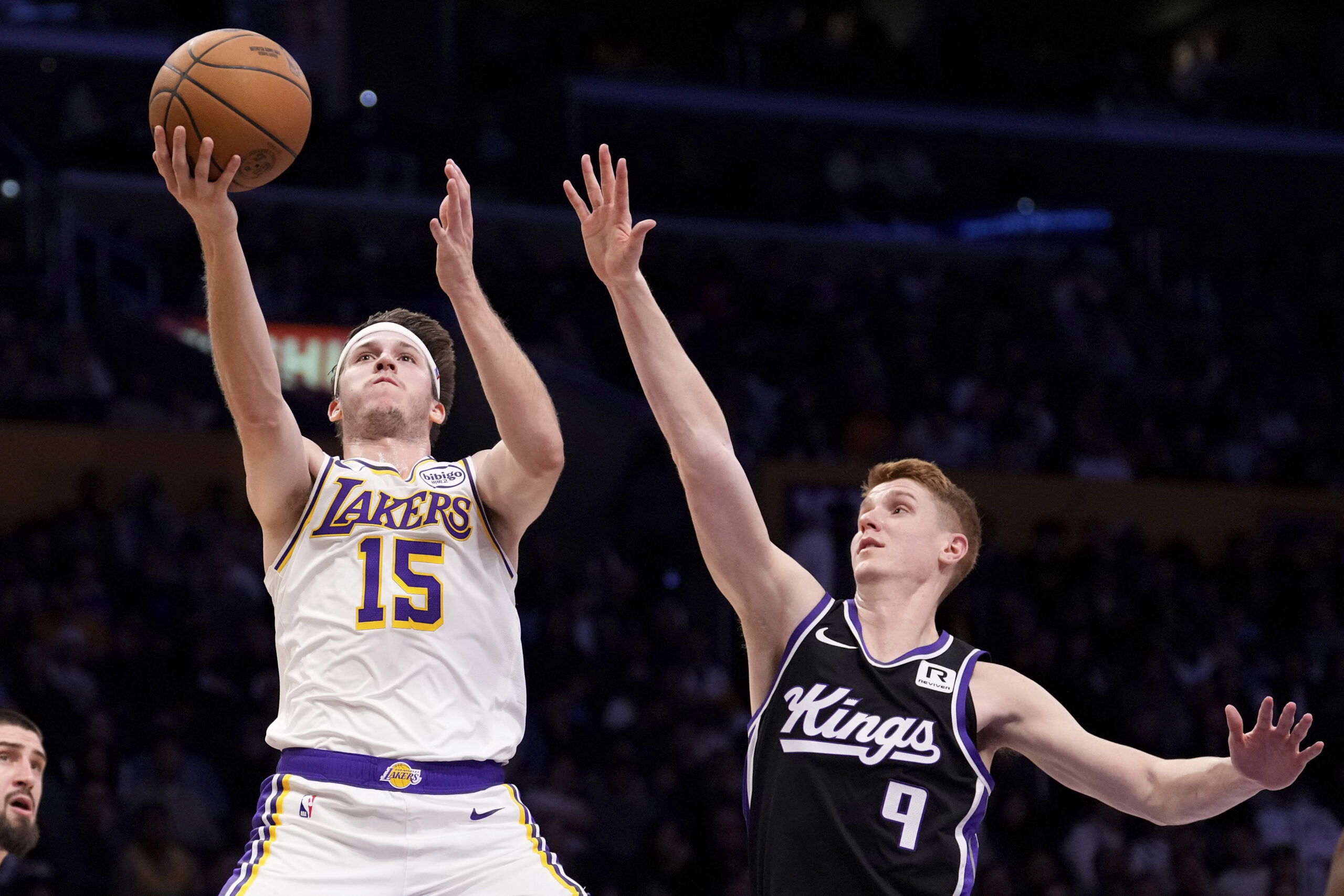 Lakers guard Austin Reaves, left, shoots as Sacramento Kings guard...