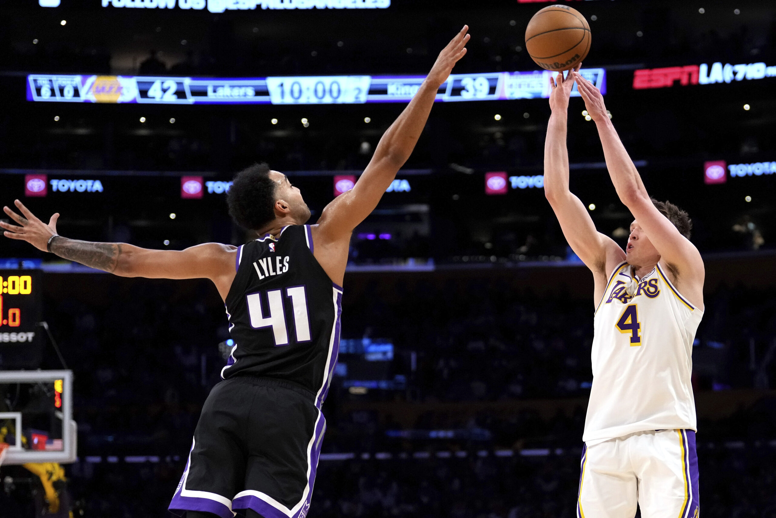 Lakers guard Dalton Knecht, right, shoots as Sacramento Kings forward...