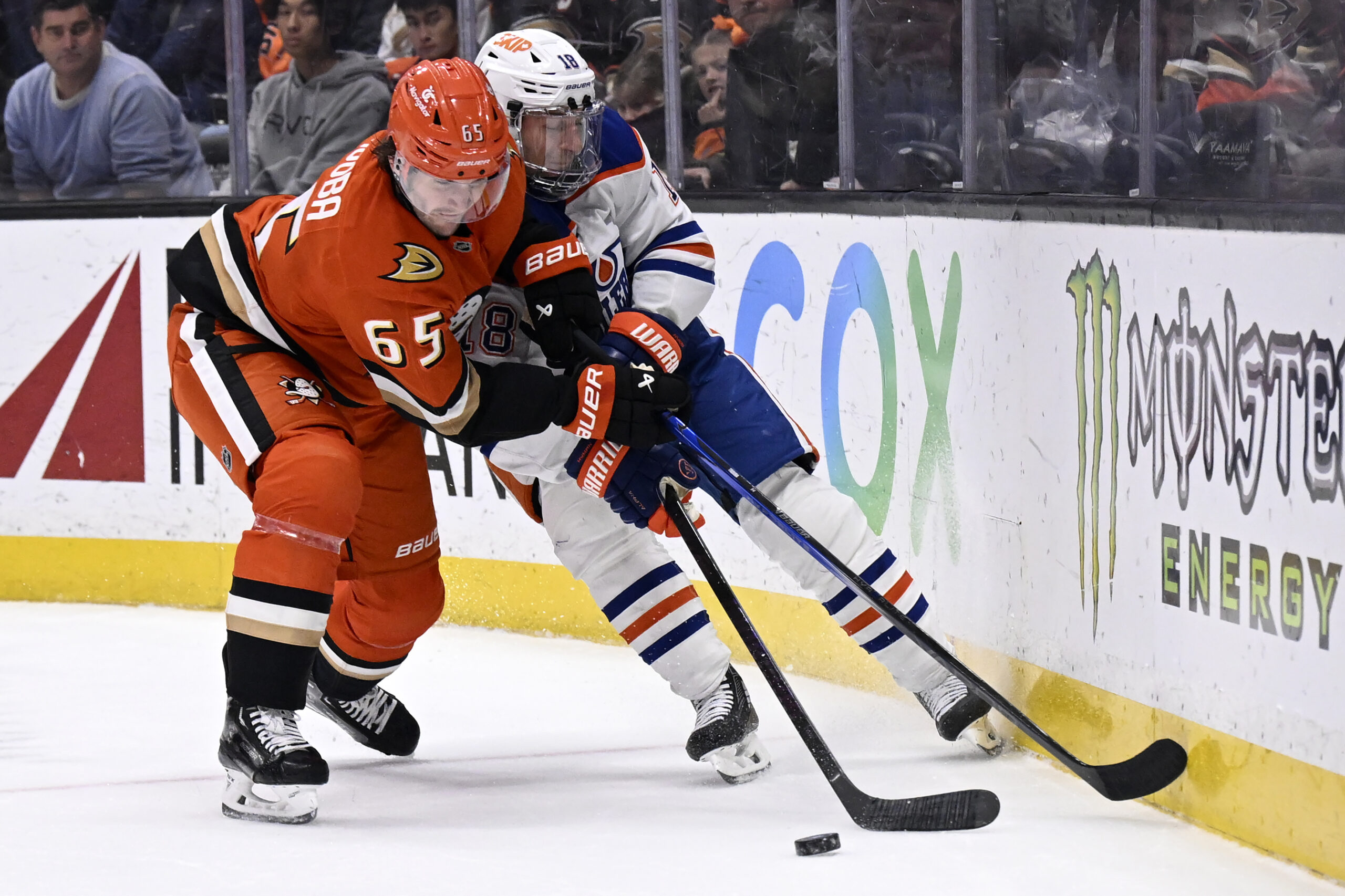 Ducks defenseman Jacob Trouba (65) and Edmonton Oilers left wing...