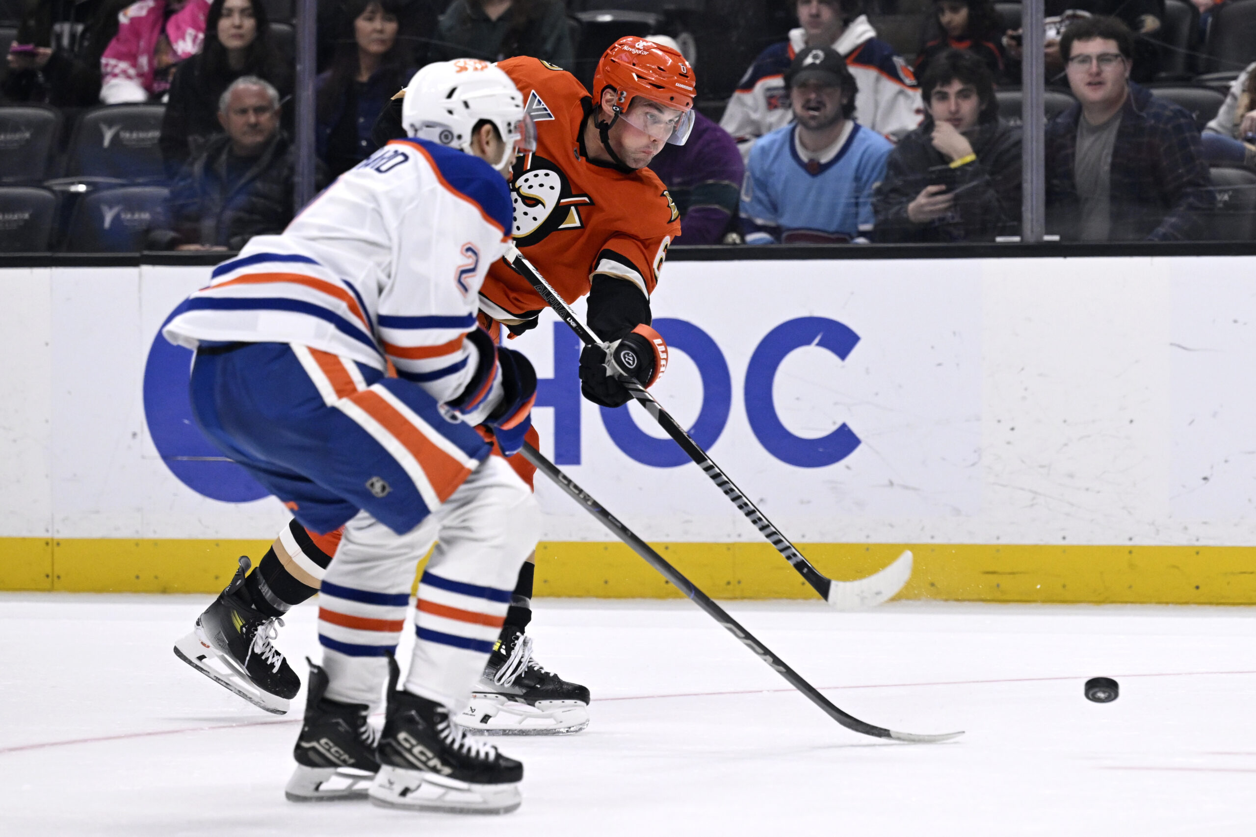 Ducks defenseman Brian Dumoulin, right, shoots against Edmonton Oilers defenseman...