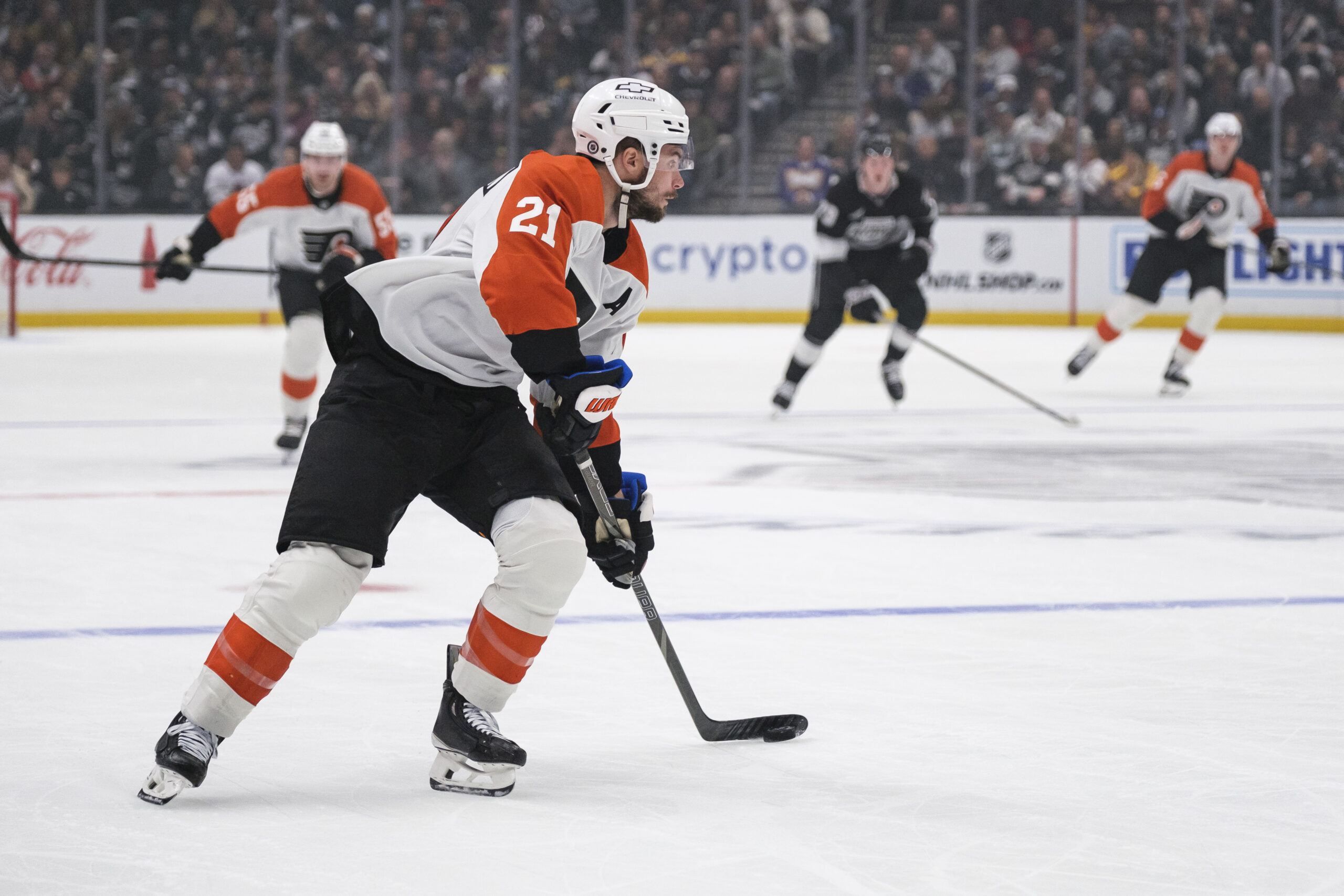 Philadelphia Flyers center Scott Laughton (21) looks to pass the...