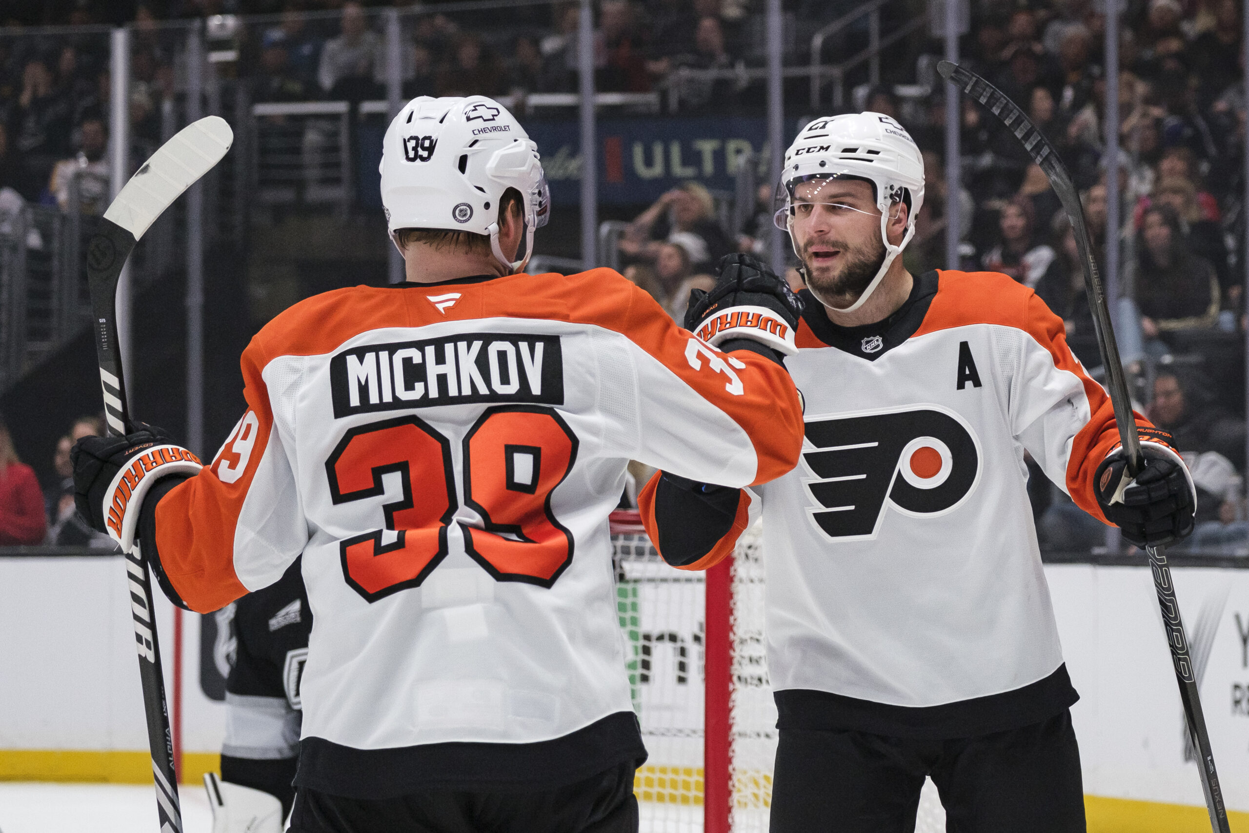 Philadelphia Flyers center Scott Laughton, right, celebrates with right wing...