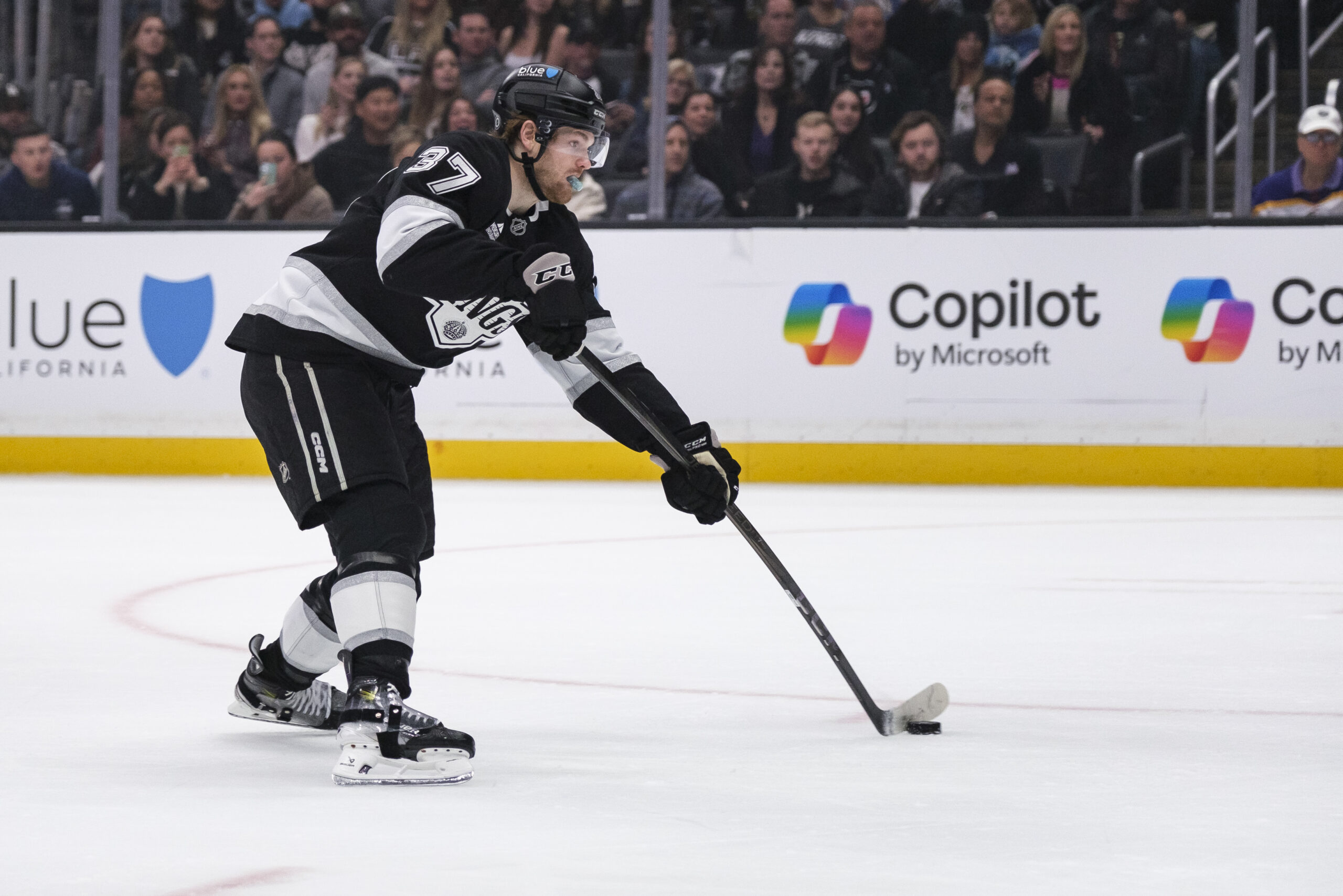 Kings left wing Warren Foegele shoots the puck and scores...