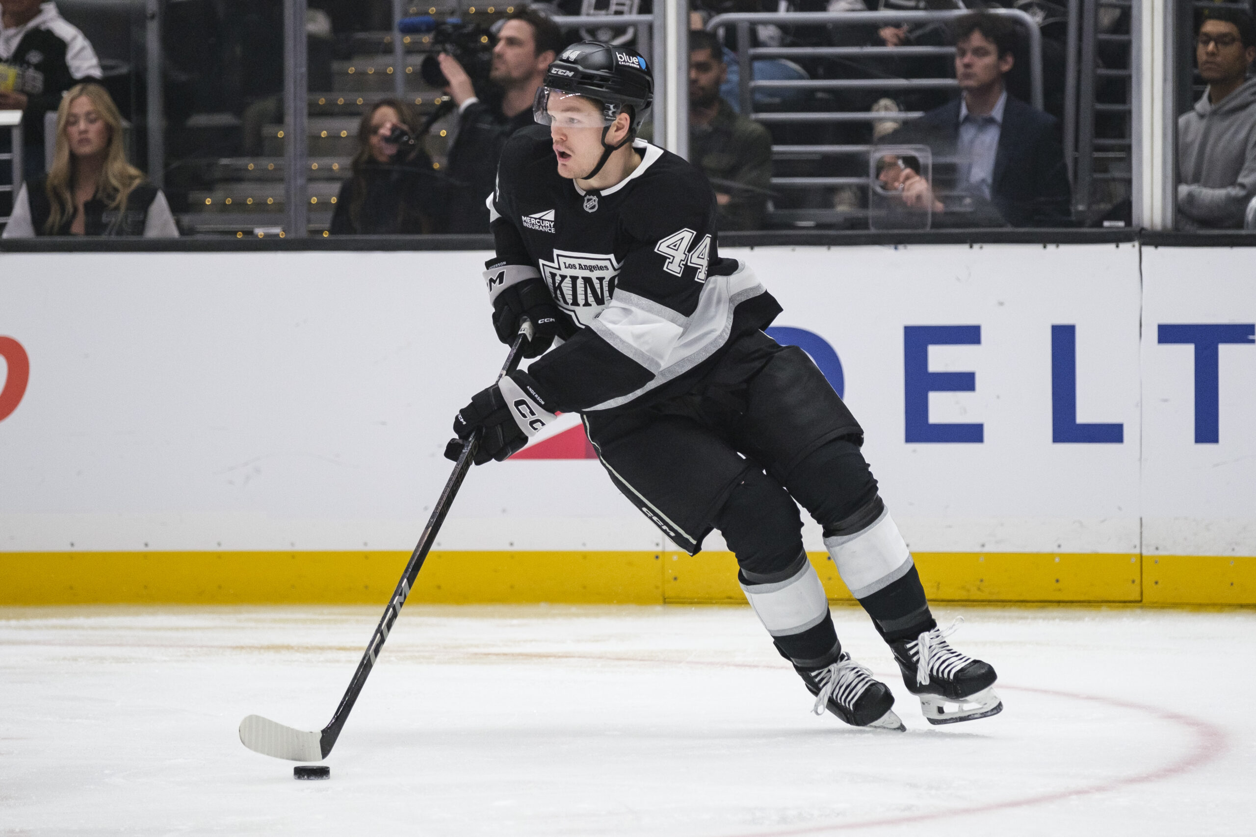 Kings defenseman Mikey Anderson (44) controls the puck during the...