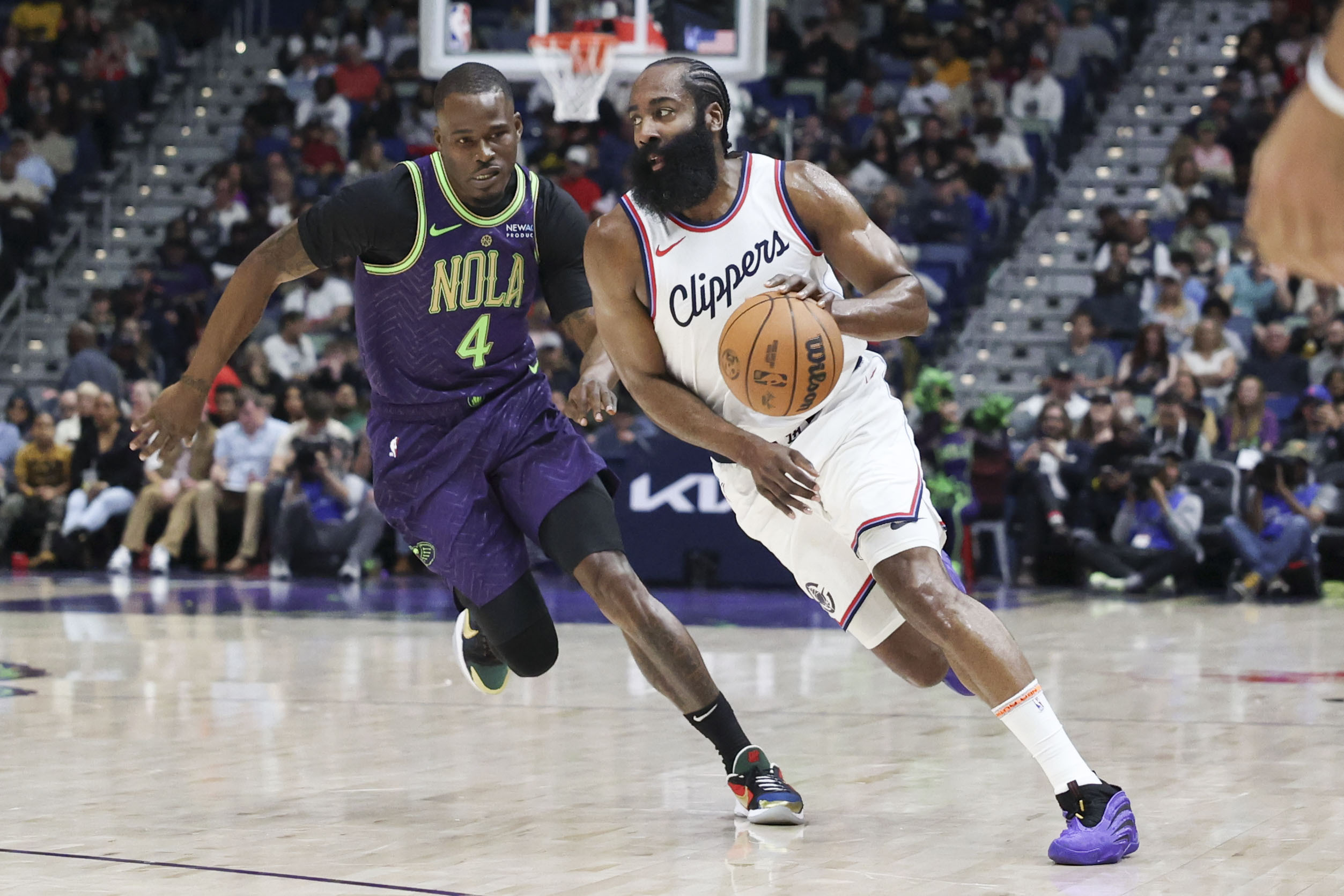 Clippers guard James Harden tries to drive past New Orleans...