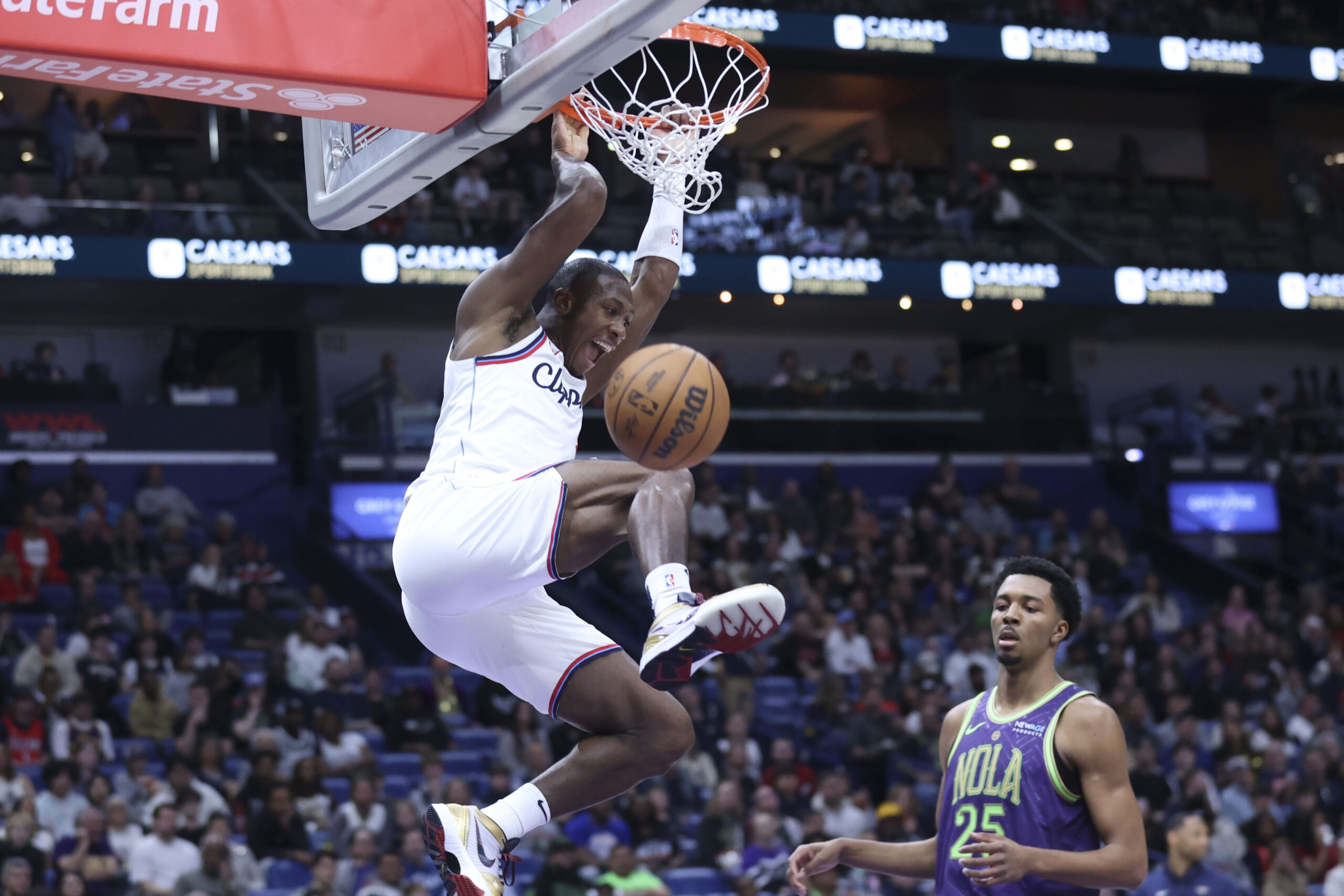 Clippers guard Kris Dunn dunks past New Orleans Pelicans guard...