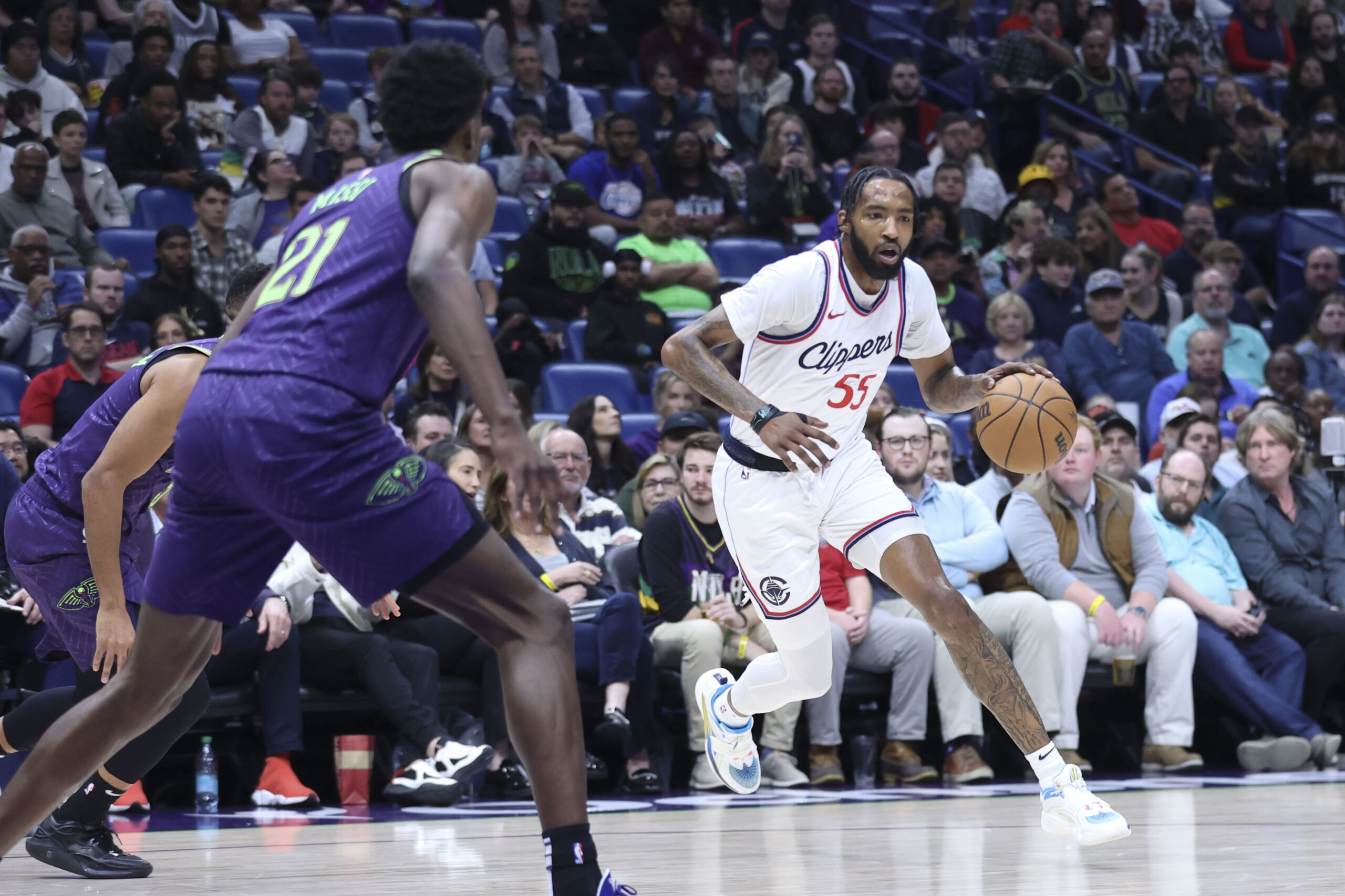 Clippers forward Derrick Jones Jr. (55) drives to the basket...