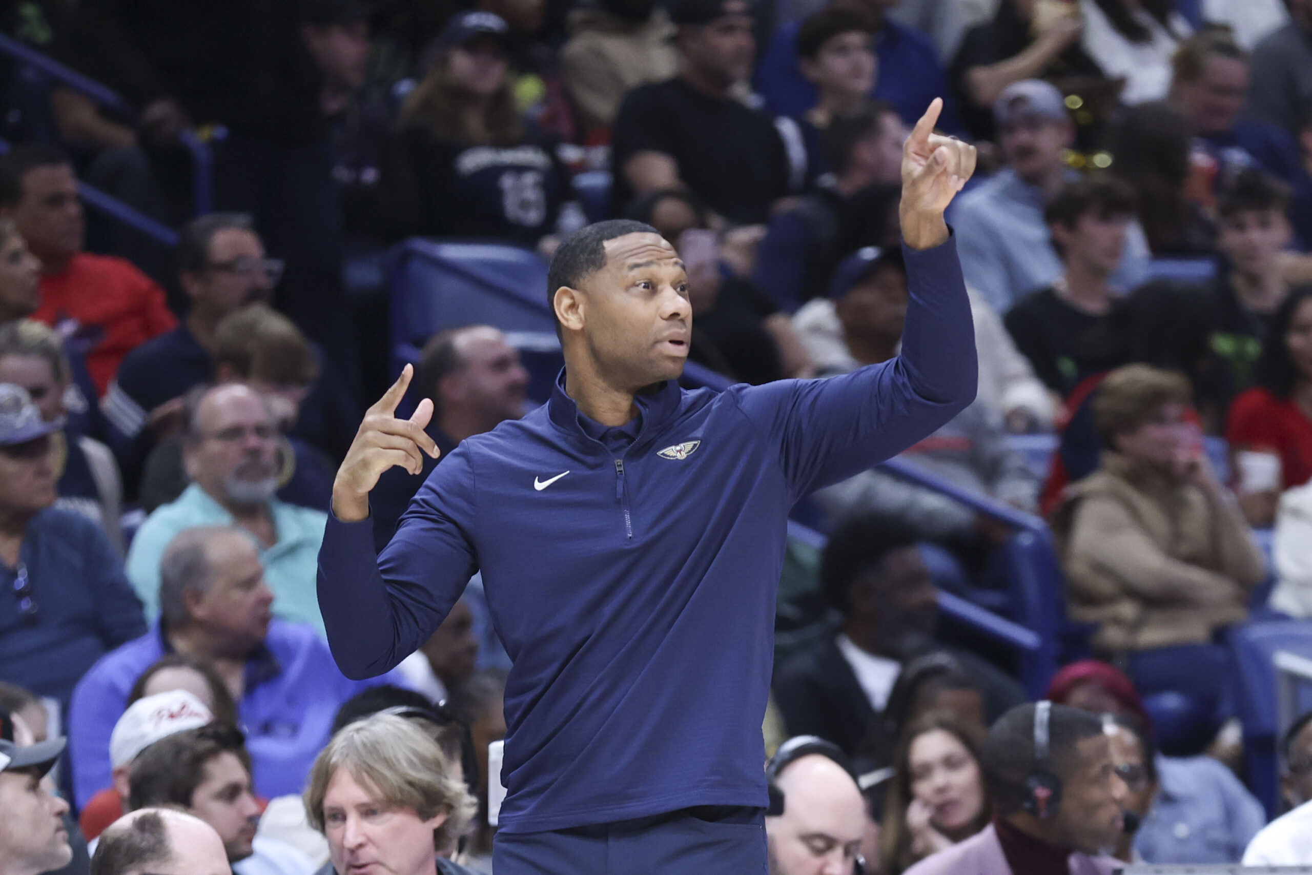 New Orleans Pelicans head coach Willie Green signals to his...