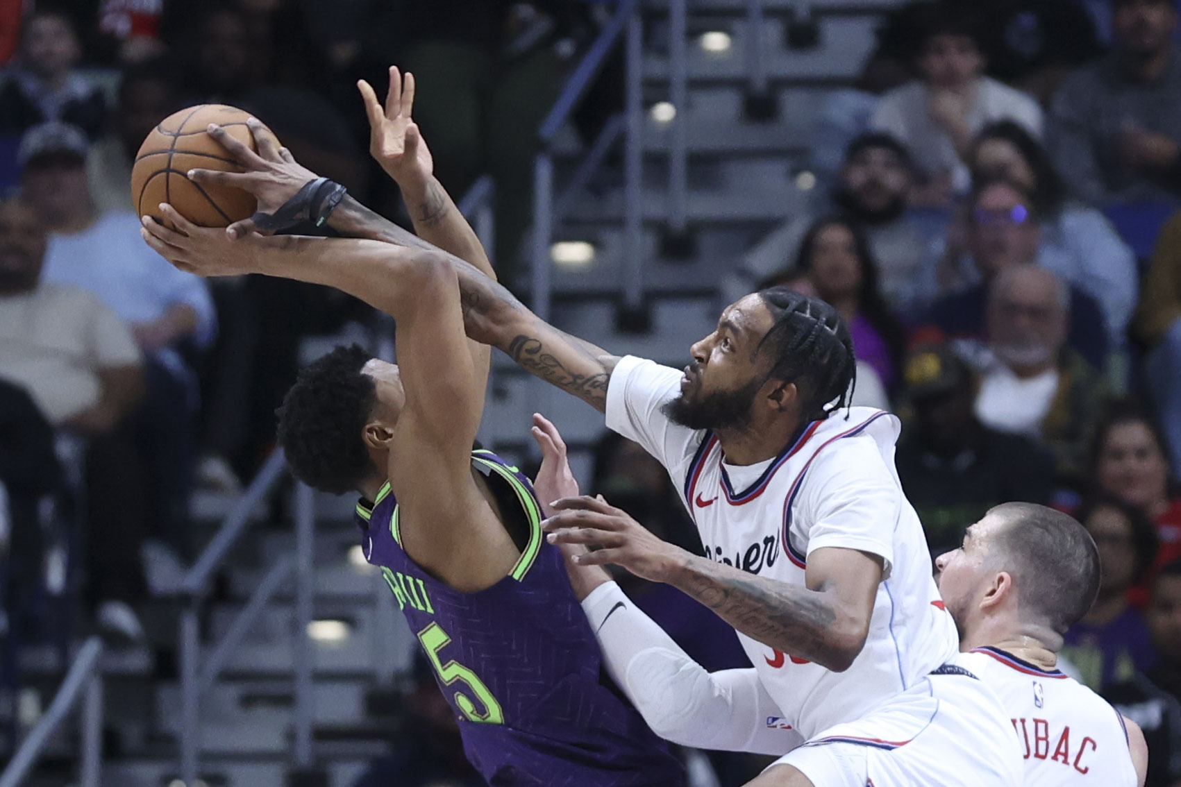 Clippers forward Derrick Jones Jr. fouls New Orleans Pelicans guard...